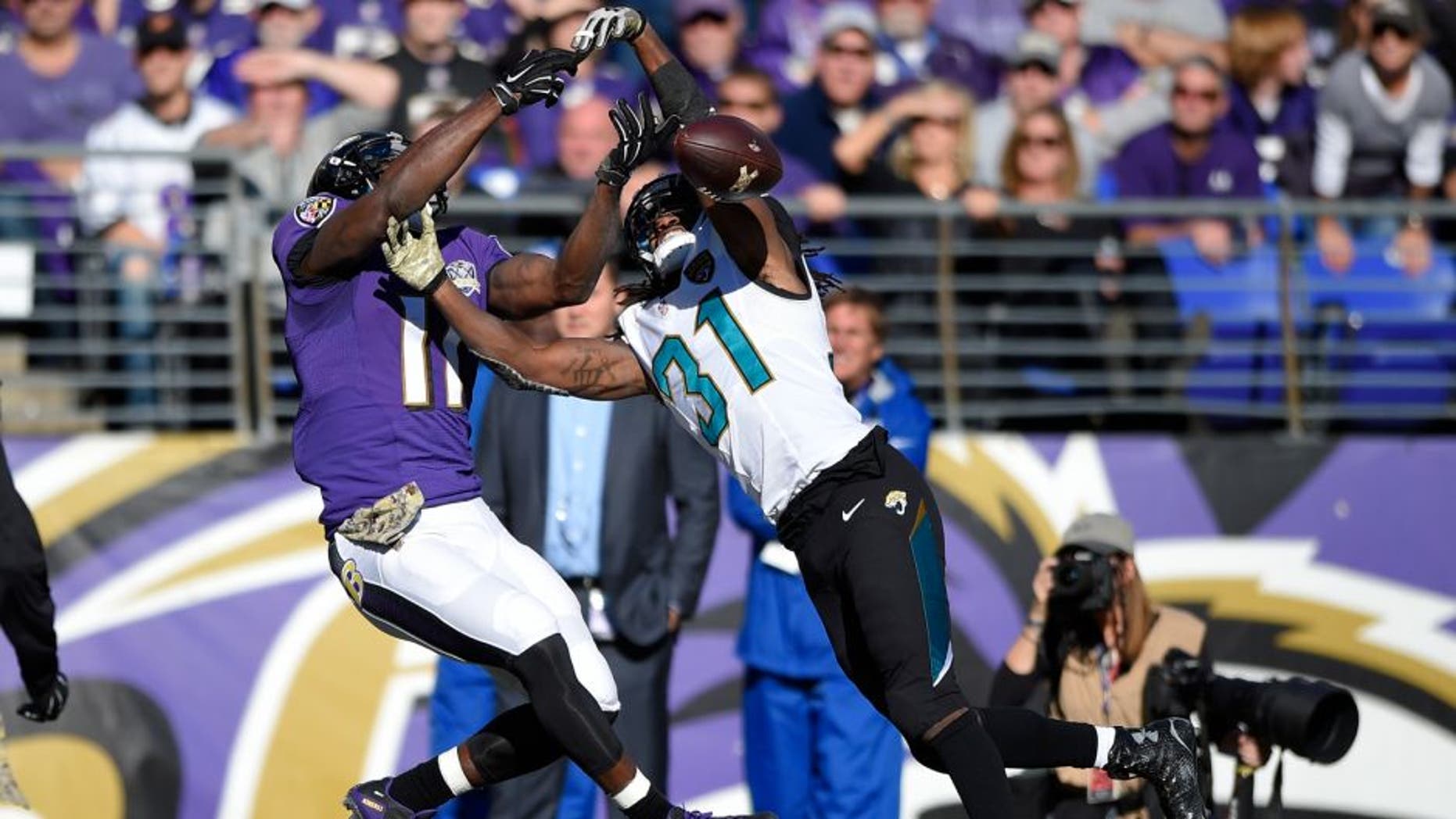 Jacksonville Jaguars cornerback Davon House, right, breaks up a pass-attempt to Baltimore Ravens wide receiver Kamar Aiken in the first half an NFL football game, Sunday, Nov. 15, 2015, in Baltimore. (AP Photo/Nick Wass)
