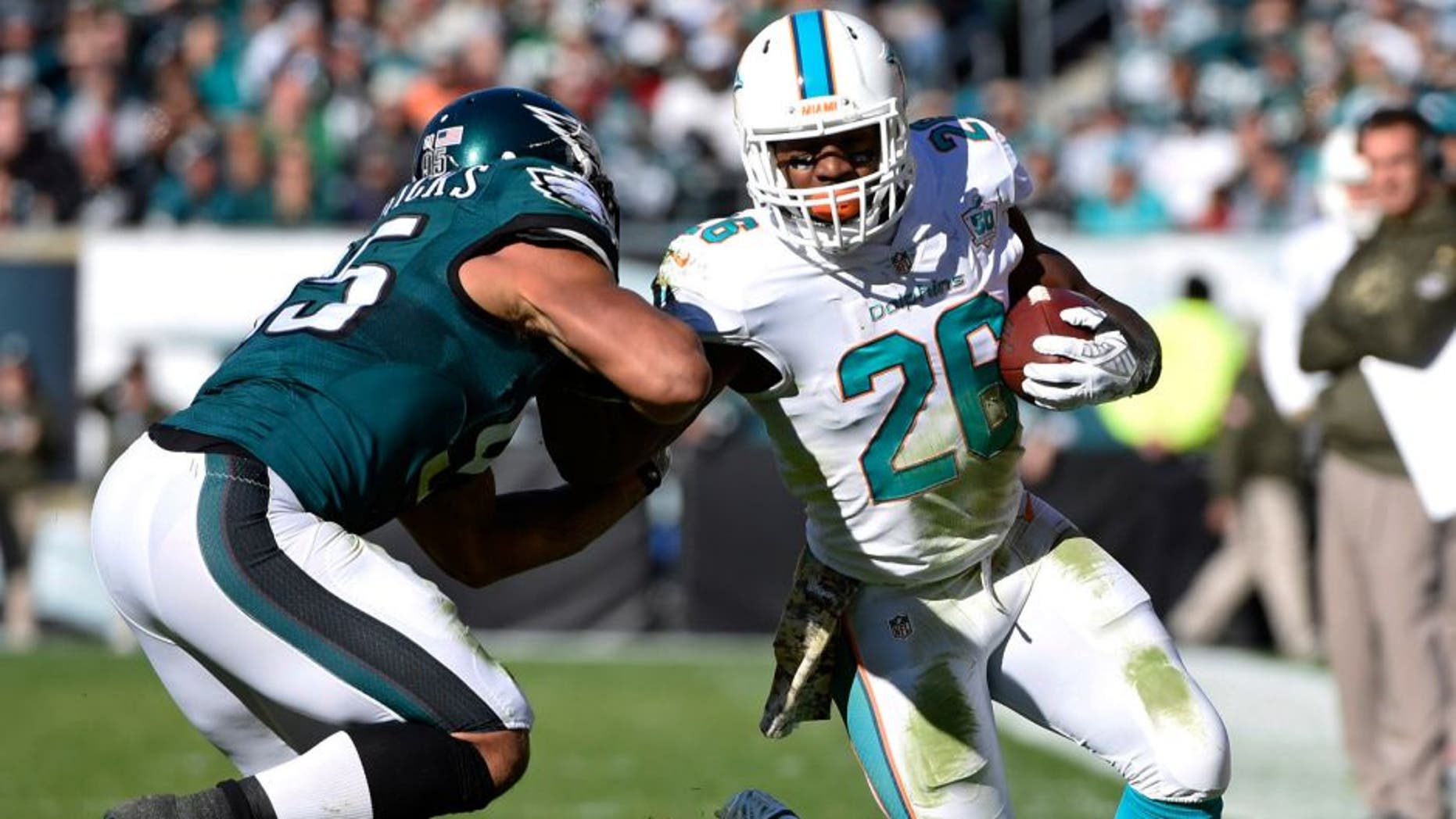 Nov 15, 2015; Philadelphia, PA, USA; Miami Dolphins running back Lamar Miller (26) is pushed out of bounds by Philadelphia Eagles inside linebacker Mychal Kendricks (95) during the first quarter at Lincoln Financial Field. Mandatory Credit: Eric Hartline-USA TODAY Sports