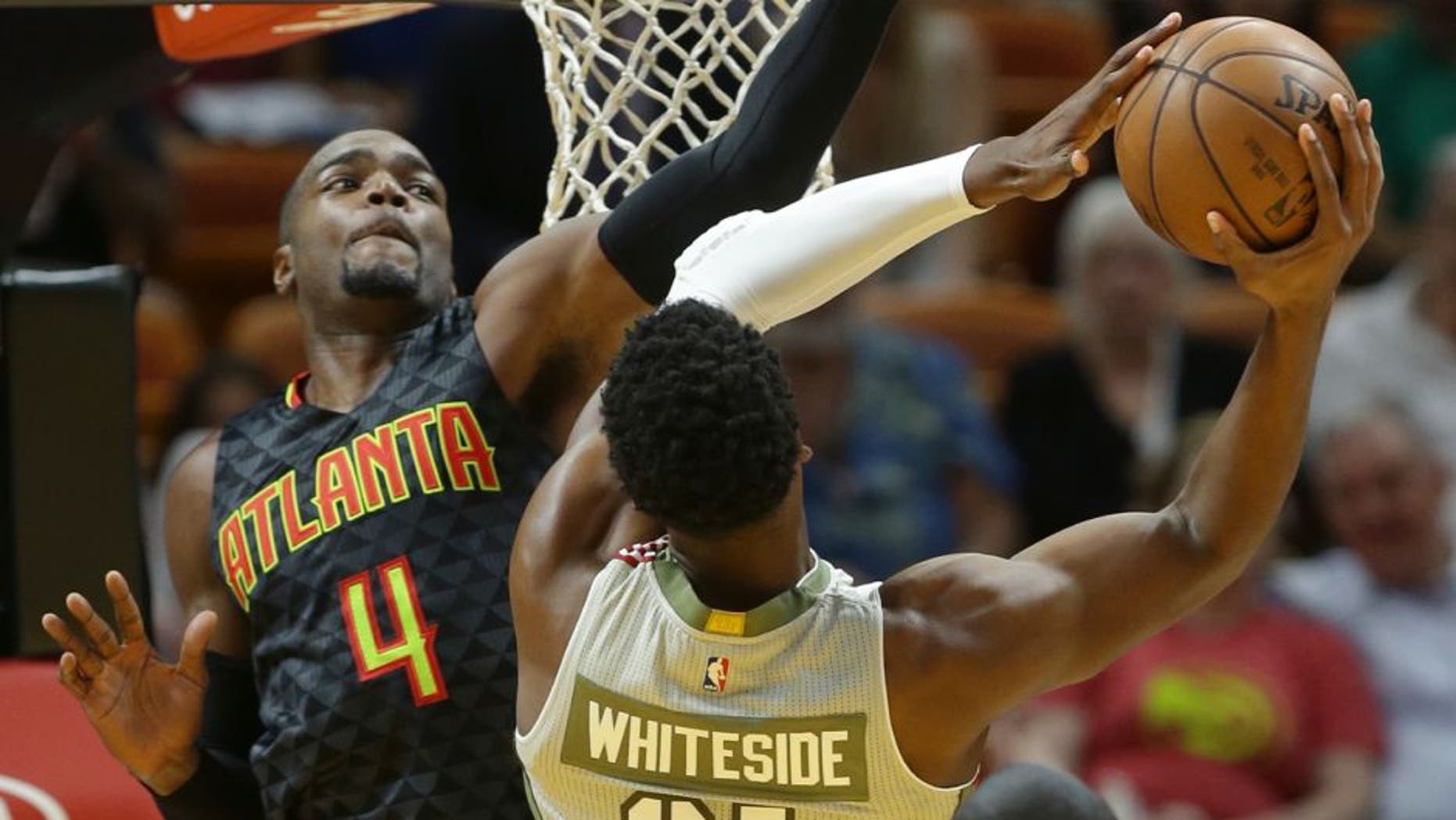 Miami Heat center Hassan Whiteside (21) goes to the basket as Atlanta Hawks forward Paul Millsap (4) defends during the first half of an NBA basketball game, Tuesday, Nov. 15, 2016, in Miami. (AP Photo/Lynne Sladky)