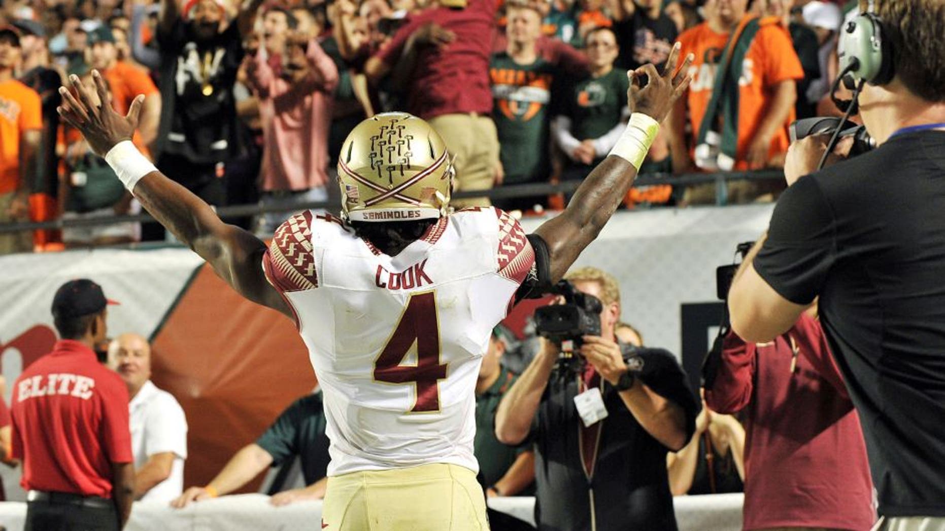 Nov 15, 2014; Miami Gardens, FL, USA; Florida State Seminoles running back Dalvin Cook (4) reacts after scoring a touchdown against the Miami Hurricanes during the second half at Sun Life Stadium. FSU won 30-26. Mandatory Credit: Steve Mitchell-USA TODAY Sports