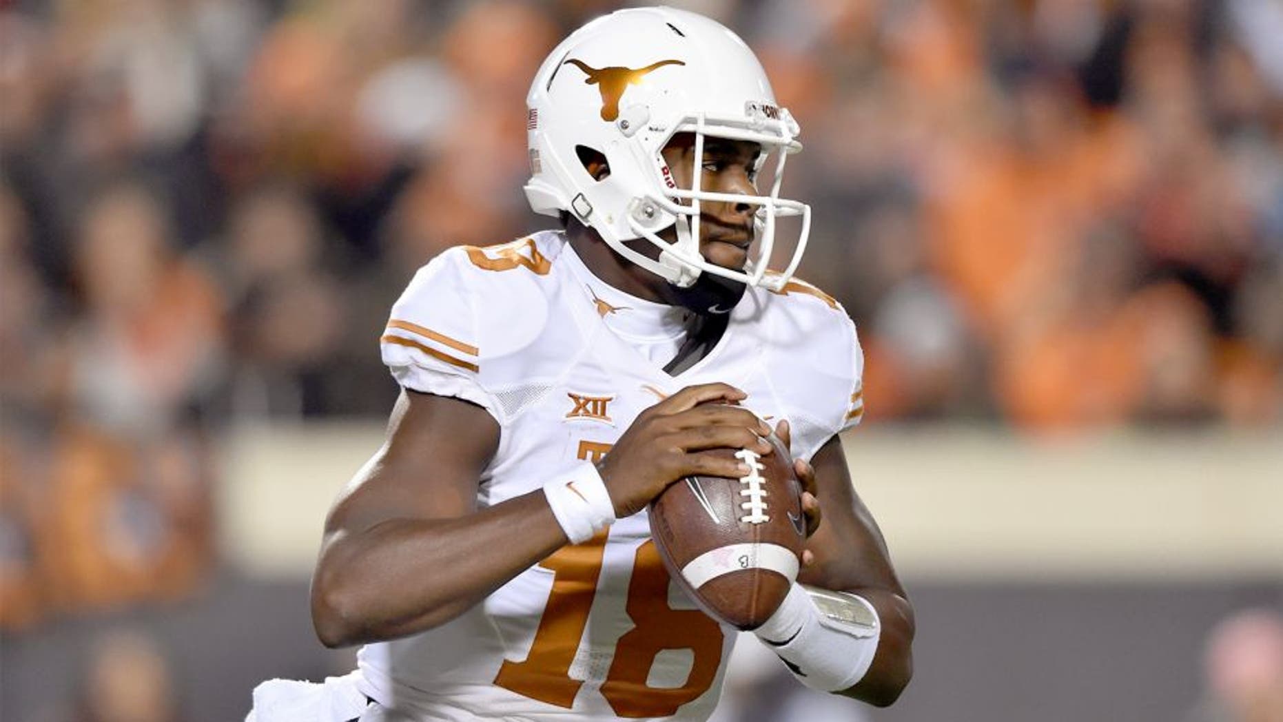 Nov 15, 2014; Stillwater, OK, USA; Texas Longhorns quarterback Tyrone Swoopes (18) looks down the field to pass against the Oklahoma State Cowboys during the first half at Boone Pickens Stadium. Mandatory Credit: Peter G. Aiken-USA TODAY Sports