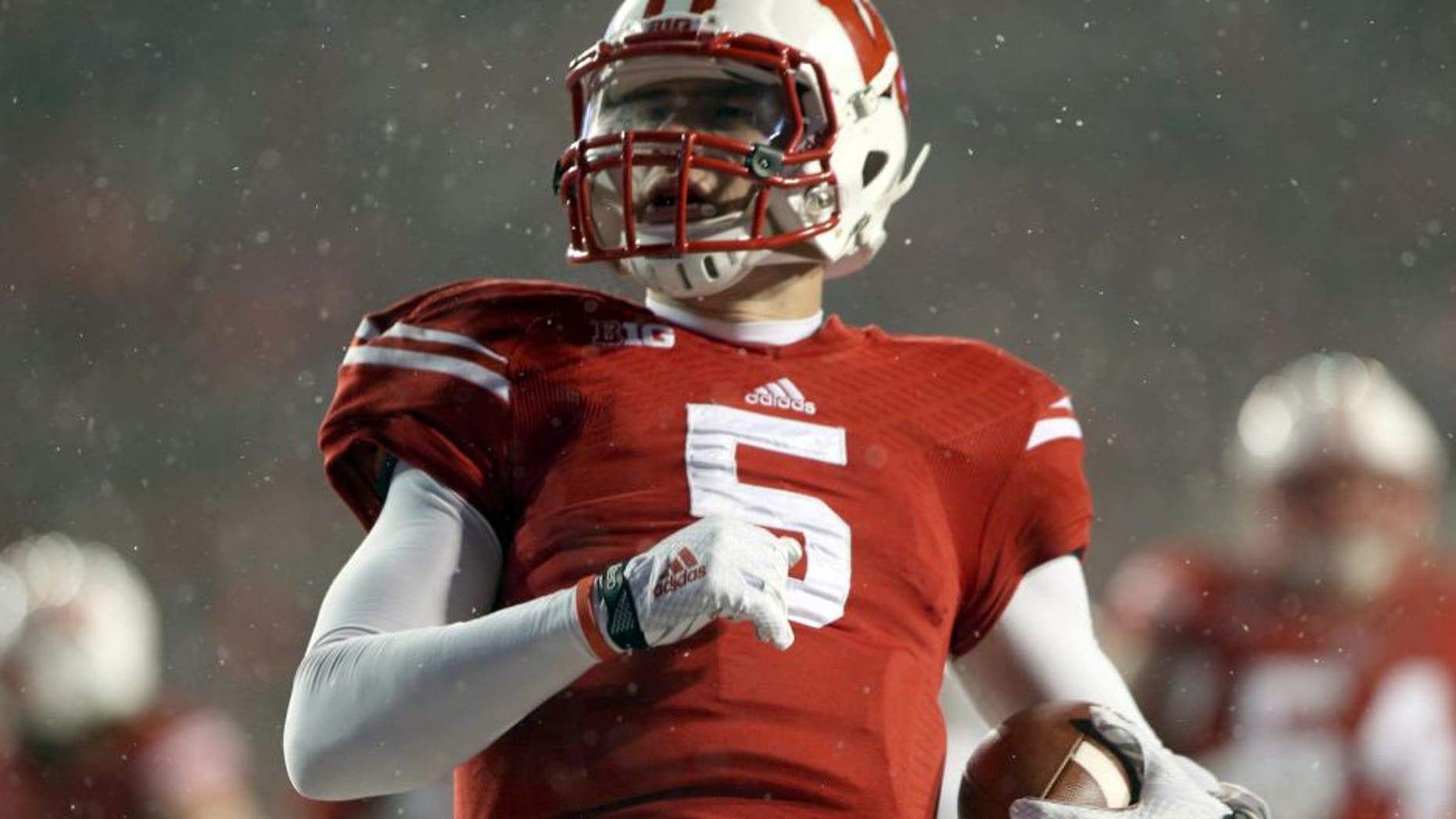Nov 15, 2014; Madison, WI, USA; Wisconsin Badgers quarterback Tanner McEvoy (5) scores a touchdown during the game with the Nebraska Cornhuskers at Camp Randall Stadium. Wisconsin defeated Nebraska 59-24. Mandatory Credit: Mary Langenfeld-USA TODAY Sports