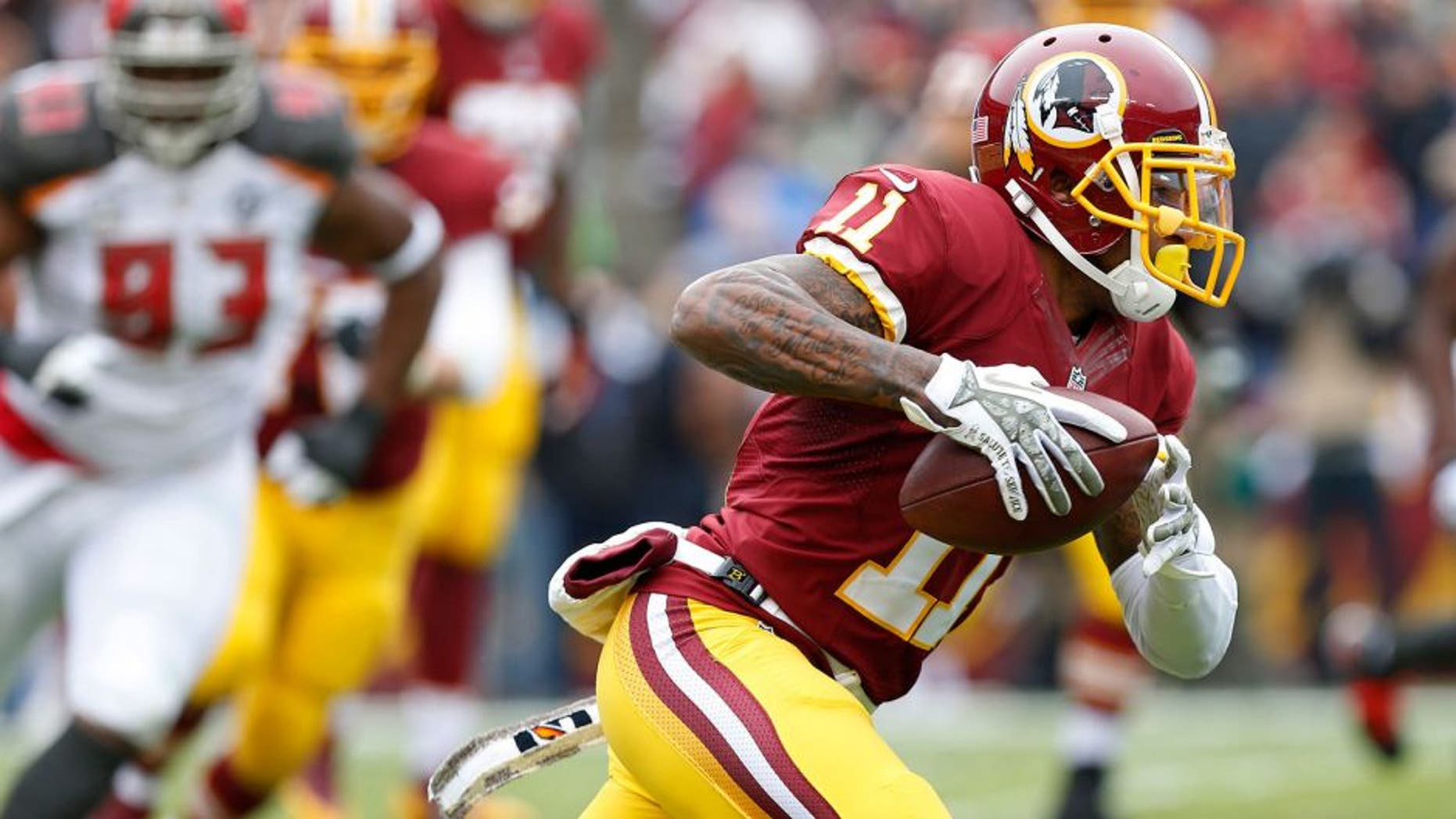 Nov 16, 2014; Landover, MD, USA; Washington Redskins wide receiver DeSean Jackson (11) runs with the ball as Tampa Bay Buccaneers defensive tackle Gerald McCoy (93) chases in the second quarter at FedEx Field. The Buccaneers won 27-7. Mandatory Credit: Geoff Burke-USA TODAY Sports
