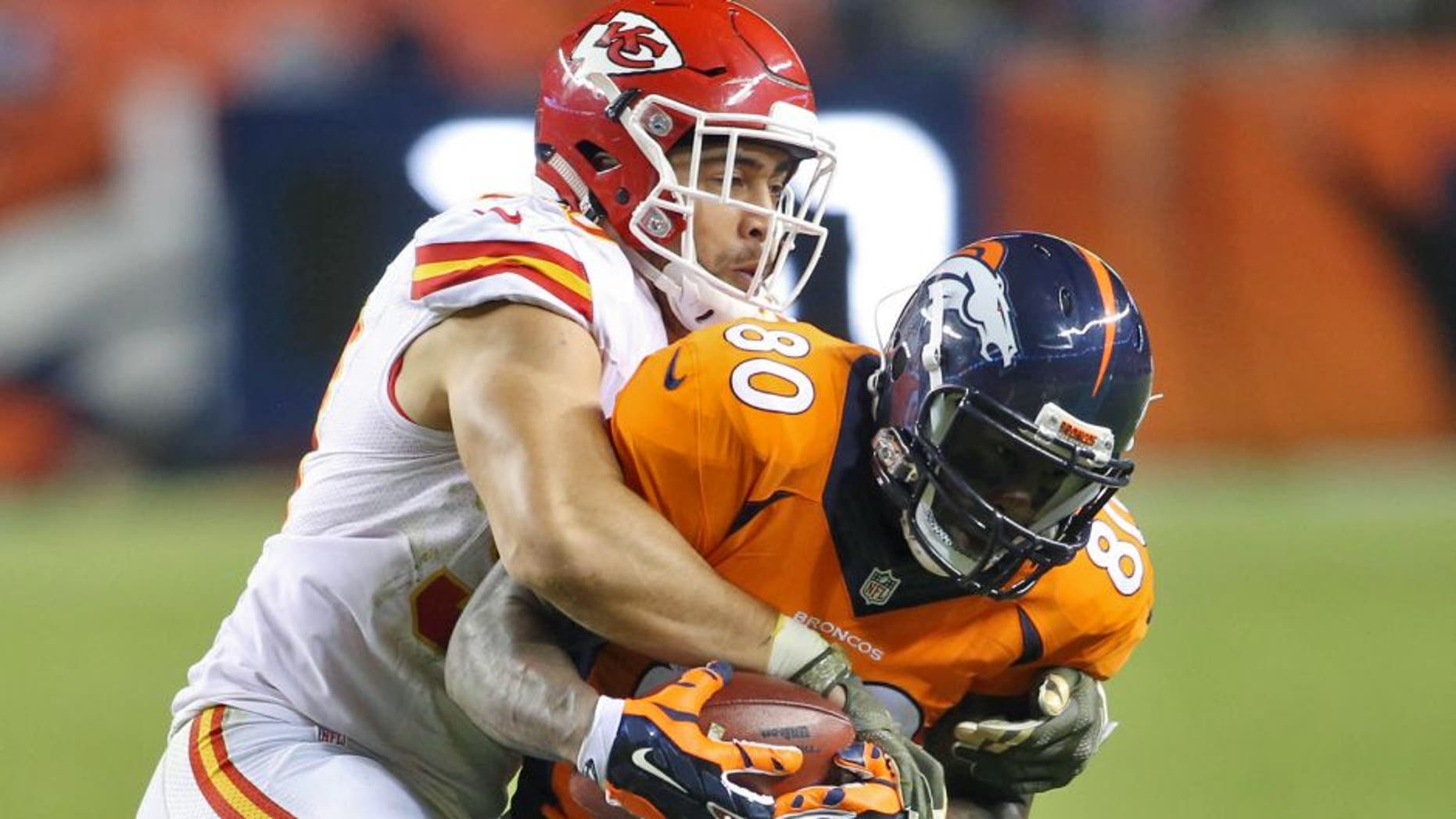 Nov 15, 2015; Denver, CO, USA; Denver Broncos tight end Vernon Davis (80) is brought down by Kansas City Chiefs inside linebacker Josh Mauga (90) during the second half at Sports Authority Field at Mile High. The Chiefs won 29-13. Mandatory Credit: Chris Humphreys-USA TODAY Sports