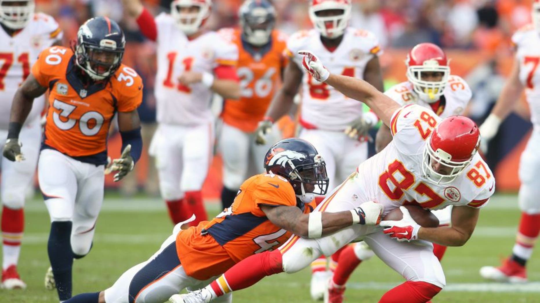 Nov 15, 2015; Denver, CO, USA; Kansas City Chiefs tight end Travis Kelce (87) is brought down by Denver Broncos strong safety T.J. Ward (43) after catching a pass during the first half at Sports Authority Field at Mile High. Mandatory Credit: Chris Humphreys-USA TODAY Sports