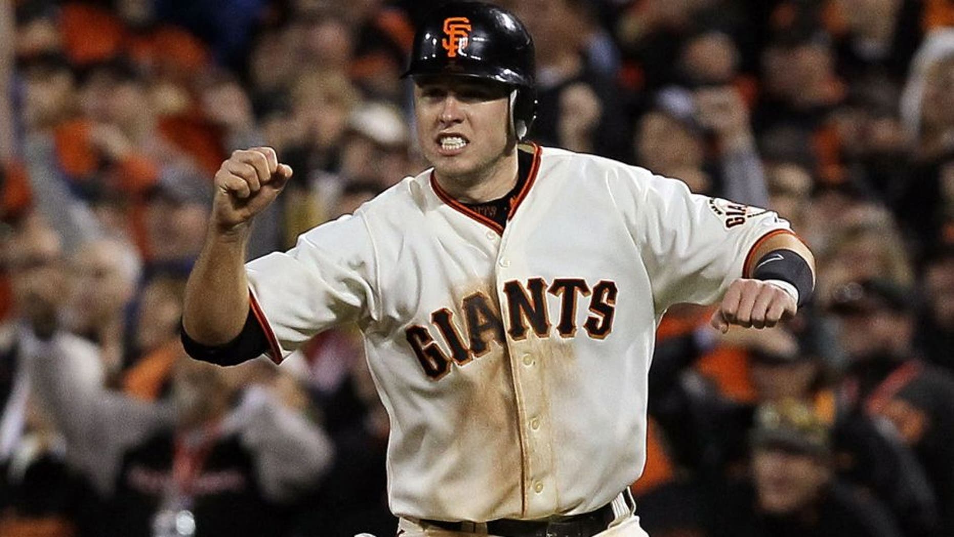 SAN FRANCISCO - OCTOBER 20: Buster Posey #28 of the San Francisco Giants reacts to Juan Uribe #5 hitting a sacrifice fly, scoring Aubrey Huff #17 to win 6-5 over the Philadelphia Phillies in Game Four of the NLCS during the 2010 MLB Playoffs at AT&T Park on October 20, 2010 in San Francisco, California. (Photo by Justin Sullivan/Getty Images) *** Local Caption *** Buster Posey