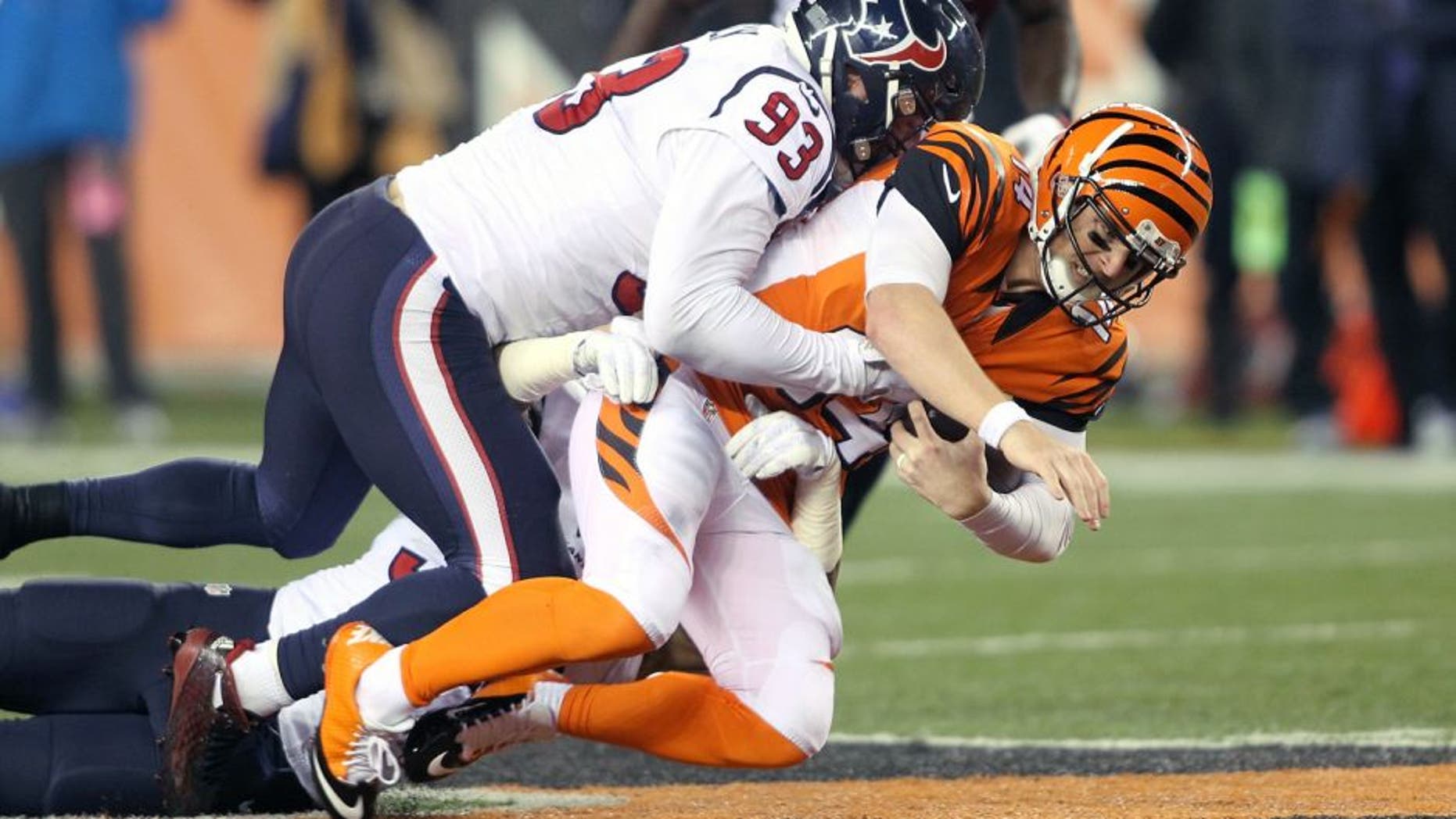 CINCINNATI, OH - NOVEMBER 16: Andy Dalton #14 of the Cincinnati Bengals is tackled by Benardrick McKinney #55 of the Houston Texans and Jared Crick #93 of the Houston Texans during the second quarter at Paul Brown Stadium on November 16, 2015 in Cincinnati, Ohio. (Photo by John Grieshop/Getty Images)