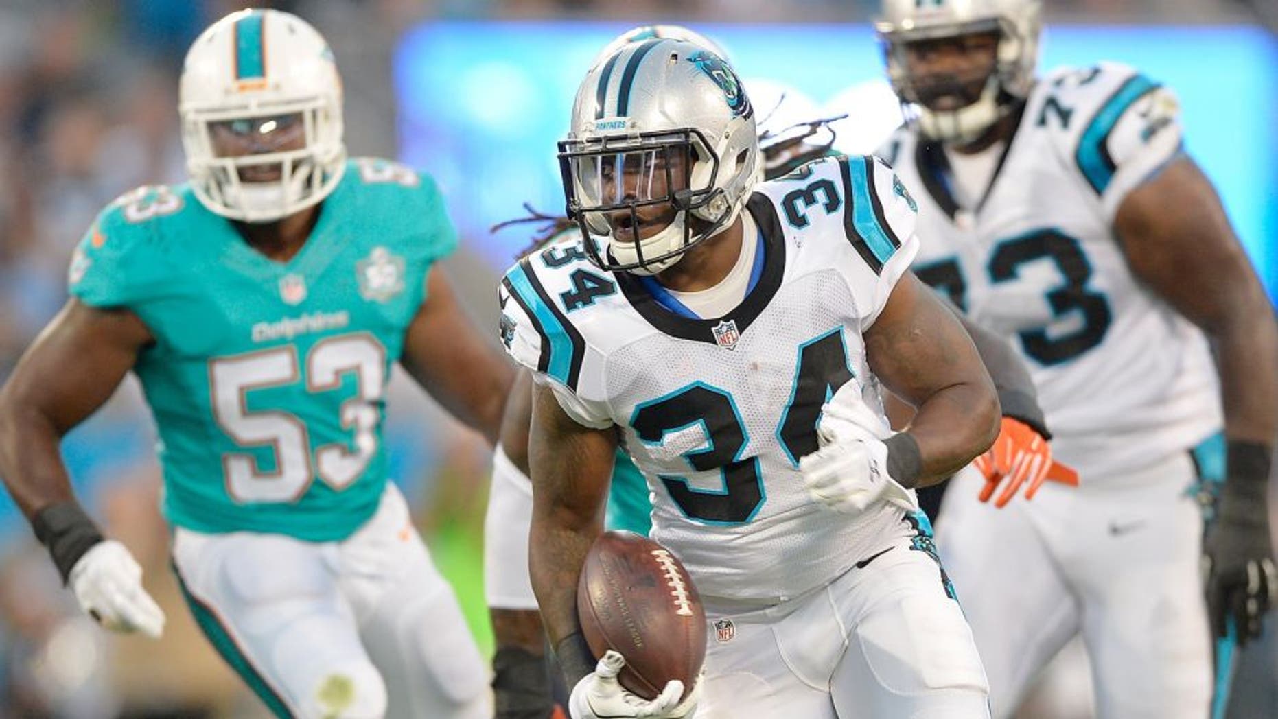 CHARLOTTE, NC - AUGUST 22: Cameron Artis-Payne #34 of the Carolina Panthers runs against the Miami Dolphins during their preseason NFL game at Bank of America Stadium on August 22, 2015 in Charlotte, North Carolina. (Photo by Grant Halverson/Getty Images)