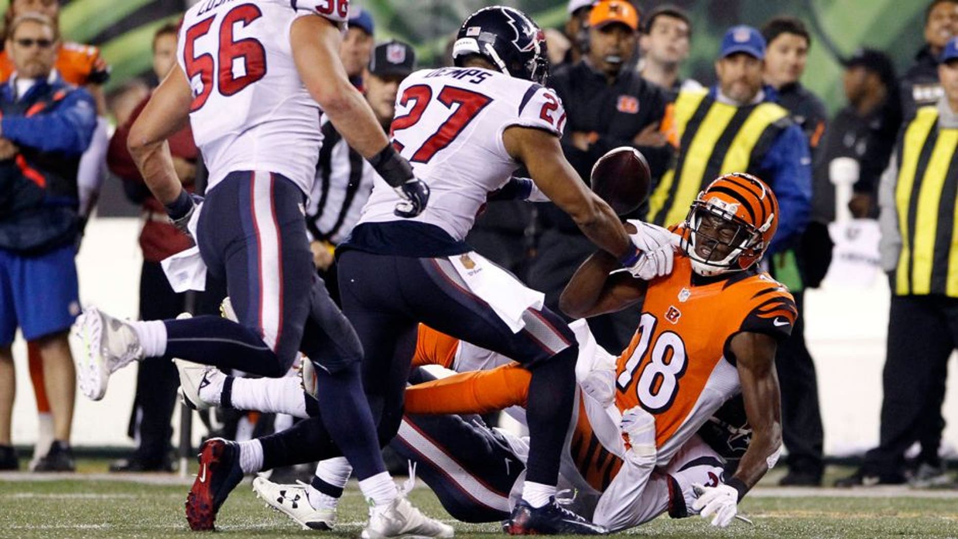 Nov 16, 2015; Cincinnati, OH, USA; Cincinnati Bengals wide receiver A.J. Green (18) fights for the ball with Houston Texans strong safety Quintin Demps (27) after fumbling the ball in the second half at Paul Brown Stadium. The Texans won 10-6. Mandatory Credit: Aaron Doster-USA TODAY Sports