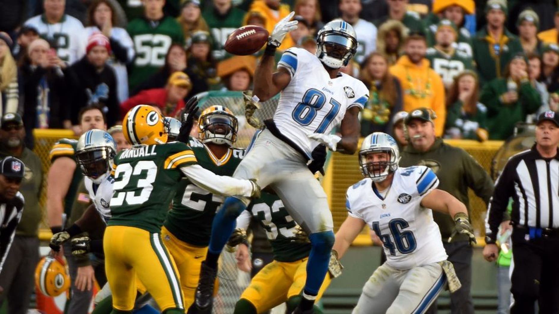 Nov 15, 2015; Green Bay, WI, USA; Green Bay Packers cornerback Damarious Randall (23) recovers an onside kick as the ball bounces off the hands of Detroit Lions wide receiver Calvin Johnson (81) in the fourth quarter at Lambeau Field. Mandatory Credit: Benny Sieu-USA TODAY Sports