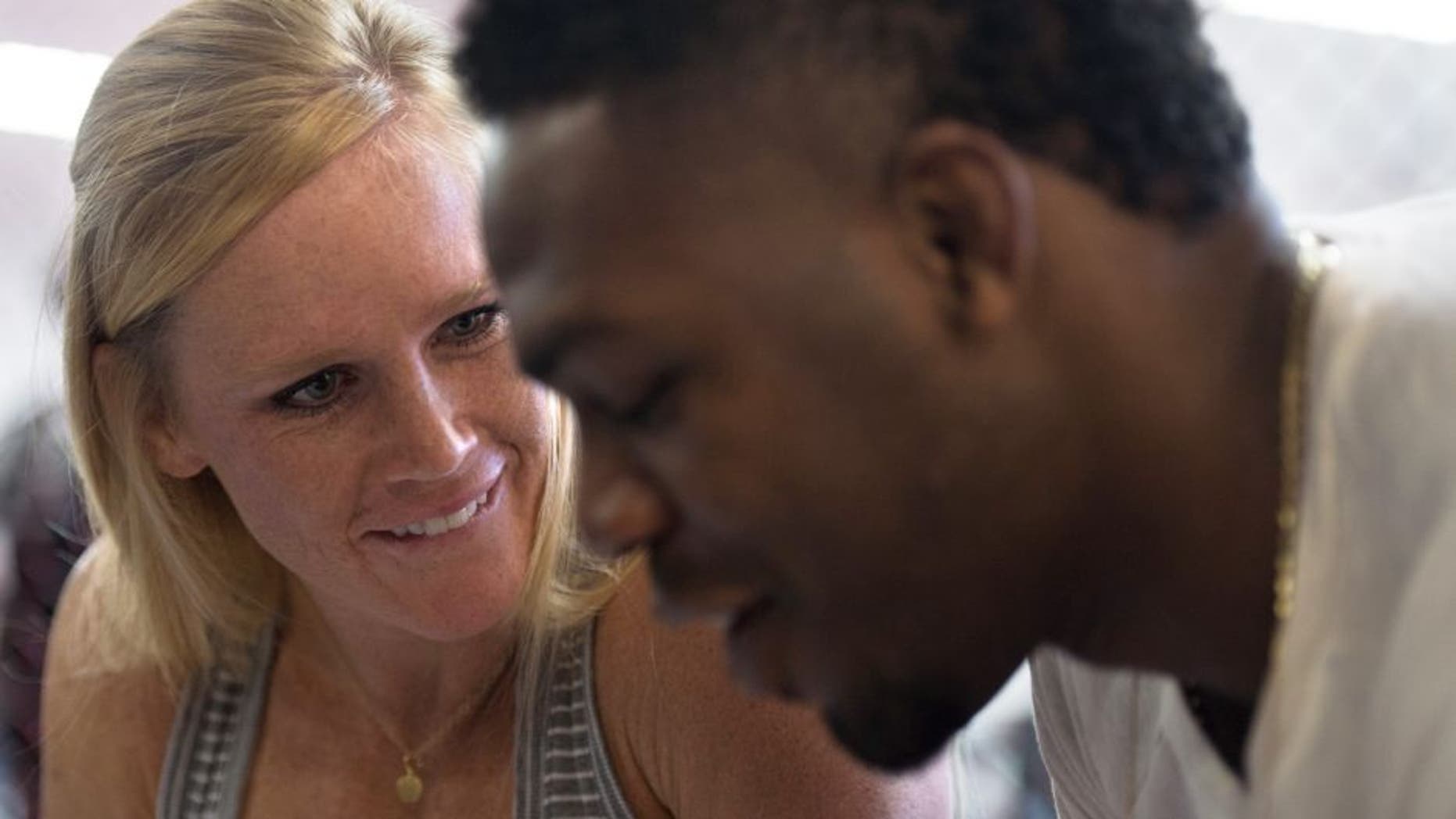 ALBUQUERQUE, NM - OCTOBER 31: (L-R) Holly Holm and Jon Jones sign autographs for fans during the Jackson Wink MMA Academy Grand Opening at Jackson's Mixed Martial Arts & Fitness on October 31, 2015 in Albuquerque, New Mexico. (Photo by Brandon Magnus/Zuffa LLC/Zuffa LLC via Getty Images)