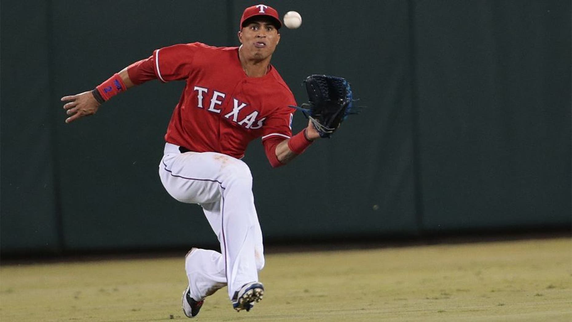 ARLINGTON, TX - SEPTEMBER 27: Leonys Martin #2 of the Texas Rangers makes a running catch hit by Alberto Callaspo of the Oakland Athletics in the seventh inning at Globe Life Park in Arlington on September 27, 2014 in Arlington, Texas. (Photo by Rick Yeatts/Getty Images)