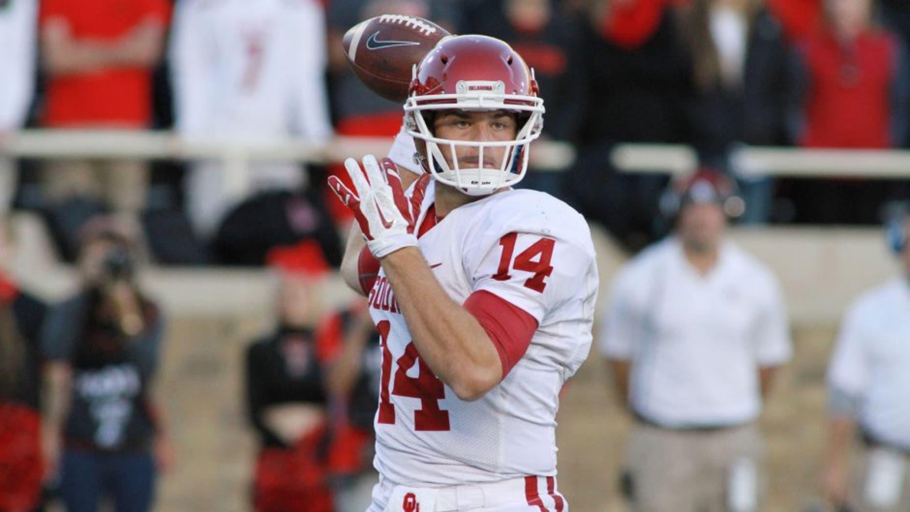 Nov 15, 2014; Lubbock, TX, USA; Oklahoma Sooners quarterback Cody Thomas (14) looks for an open receiver against the Texas Tech Red Raiders in the second half at Jones AT&T Stadium. Mandatory Credit: Michael C. Johnson-USA TODAY Sports