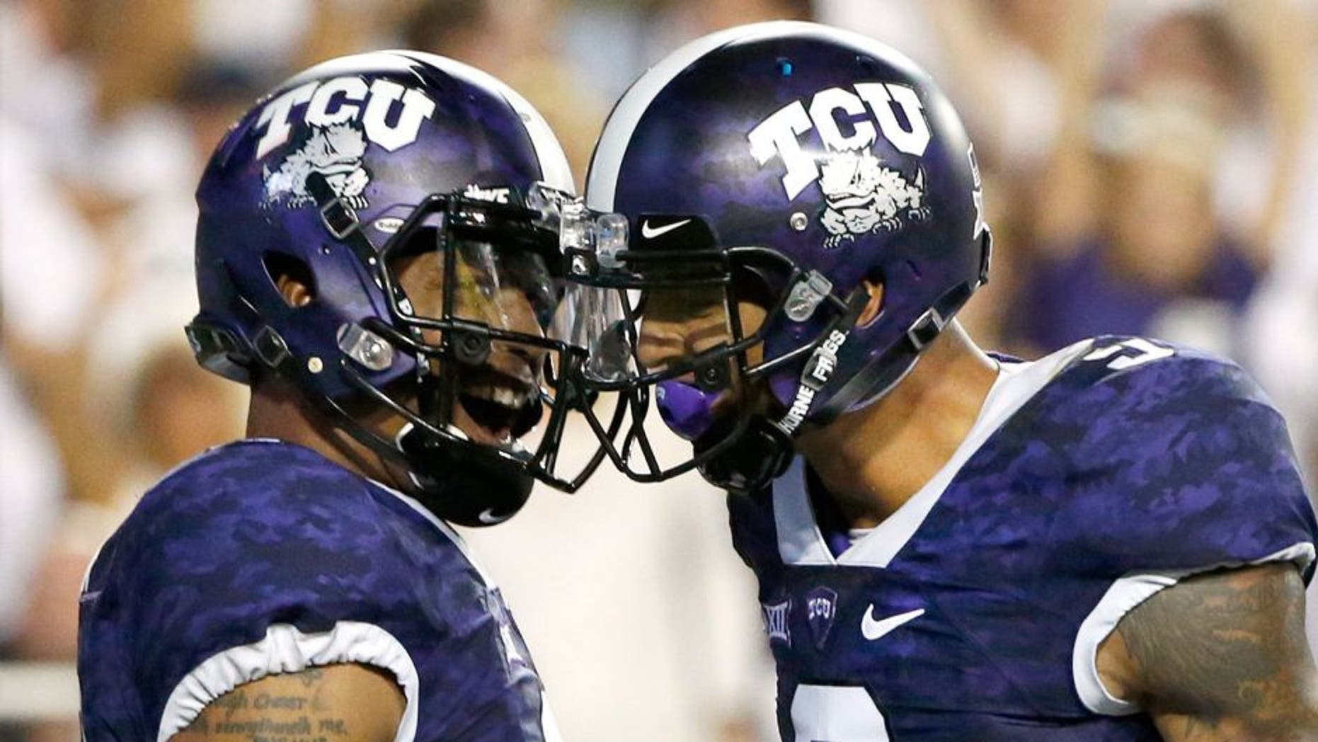 FORT WORTH, TX - SEPTEMBER 19: (L-R) Trevone Boykin #2 of the TCU Horned Frogs celebrates with teammate Josh Doctson #9 after Boykin scored on a touchdown run in the second quarter against the Southern Methodist Mustangs at Amon G. Carter Stadium on September 19, 2015 in Fort Worth, Texas. (Photo by Ron Jenkins/Getty Images)