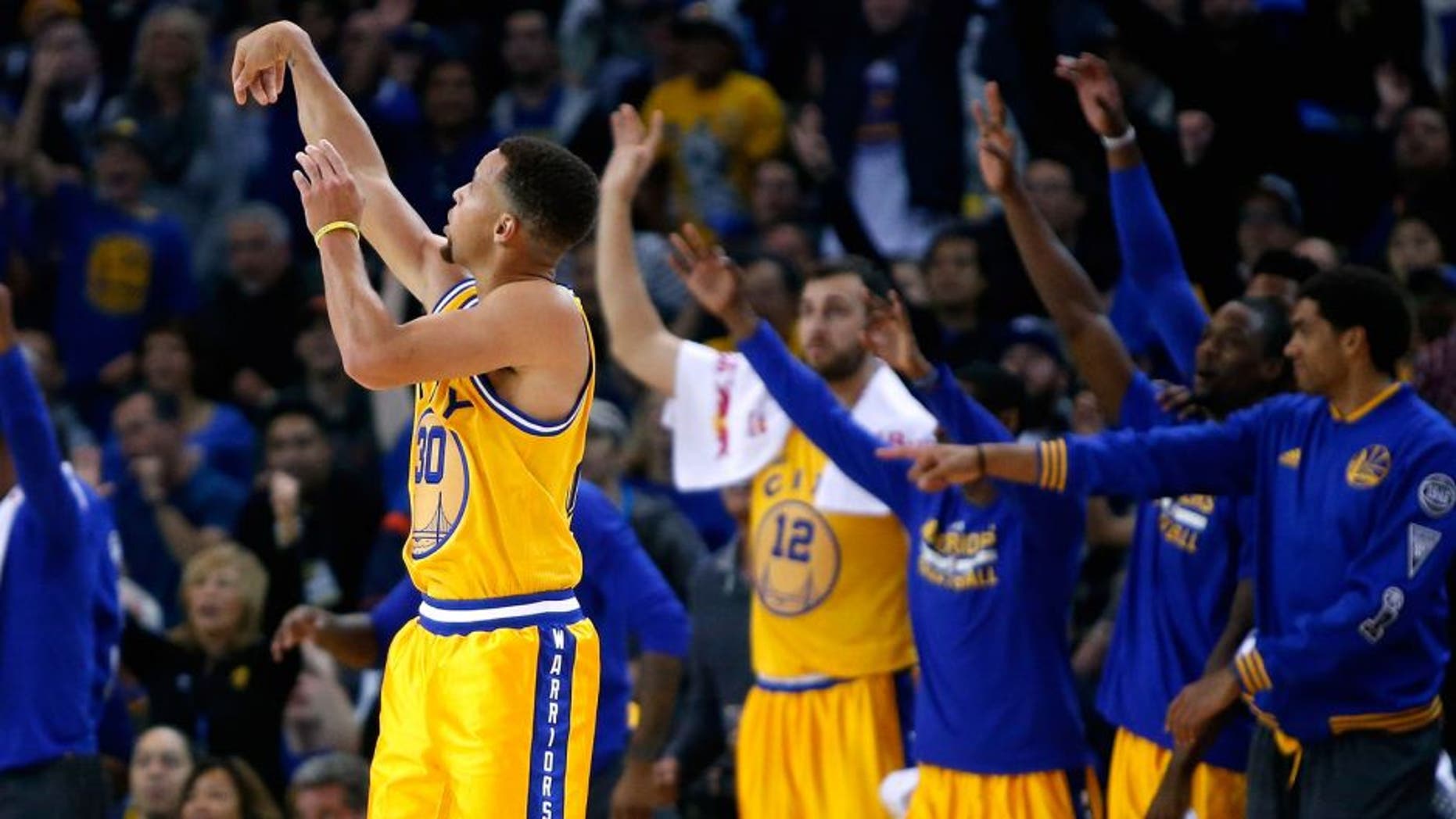 OAKLAND, CA - NOVEMBER 17: Stephen Curry #30 of the Golden State Warriors watches a three-point basket go in during their game against the Toronto Raptors at ORACLE Arena on November 17, 2015 in Oakland, California. NOTE TO USER: User expressly acknowledges and agrees that, by downloading and or using this photograph, User is consenting to the terms and conditions of the Getty Images License Agreement. (Photo by Ezra Shaw/Getty Images)