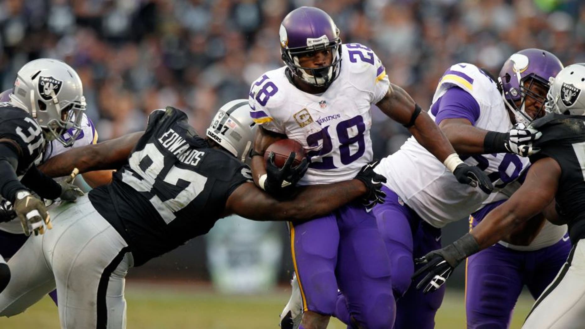 Nov 15, 2015; Oakland, CA, USA; Minnesota Vikings running back Adrian Peterson (28) runs the ball against the Oakland Raiders in the fourth quarter at O.co Coliseum. The Vikings defeated the Raiders 30-14. Mandatory Credit: Cary Edmondson-USA TODAY Sports