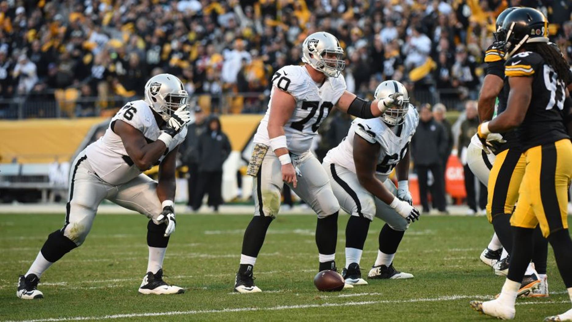 PITTSBURGH, PA - NOVEMBER 8: Center Tony Bergstrom #70 of the Oakland Raiders signals at the line of scrimmage as guards J'Marcus Webb #76 and Gabe Jackson #66 look on during a game against the Pittsburgh Steelers at Heinz Field on November 8, 2015 in Pittsburgh, Pennsylvania. The Steelers defeated the Raiders 38-35. (Photo by George Gojkovich/Getty Images)