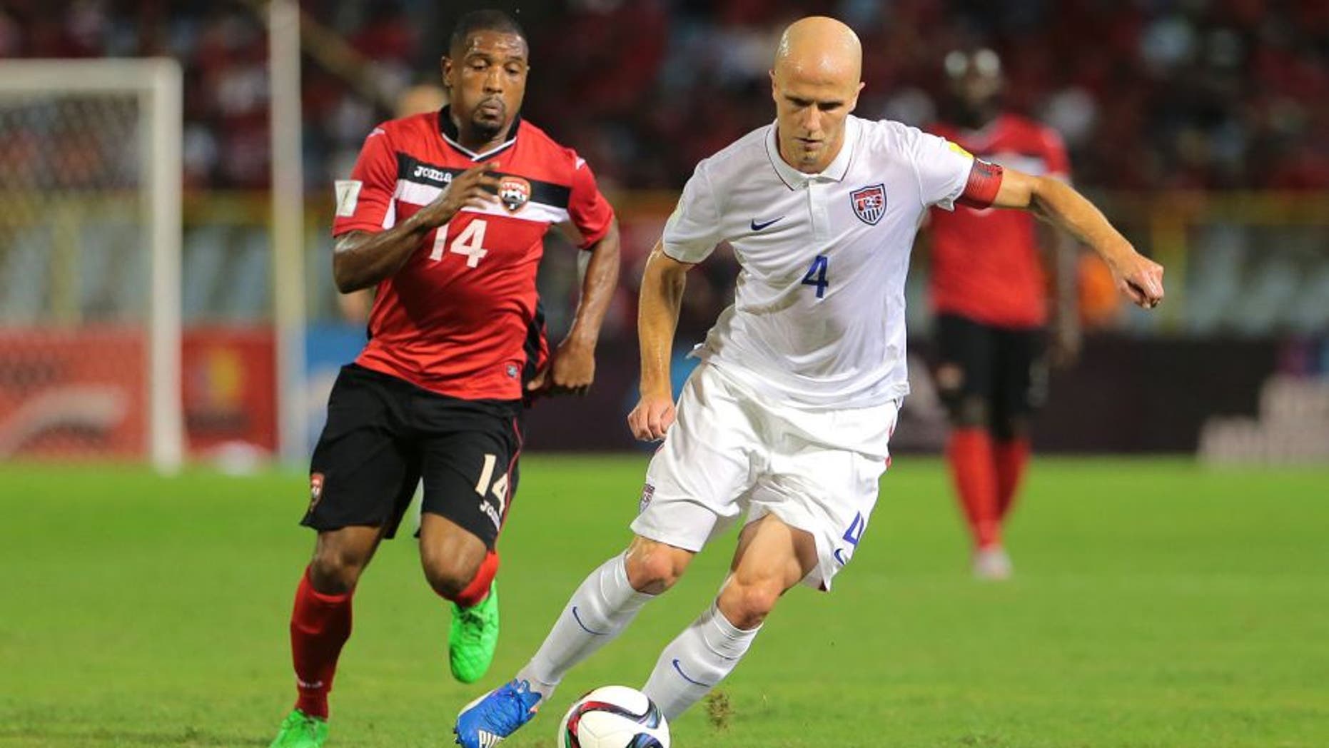 PORT OF SPAIN, TRINIDAD & TOBAGO - NOVEMBER 17: Usa's captain Michael Bradley #4 makes an attacking run as T&T's Andre Boucaud #14 chases during a World Cup Qualifier between Trinidad and Tobago and USA as part of the FIFA World Cup Qualifiers for Russia 2018 at Hasely Crawford Stadium on November 17, 2015 in Port of Spain, Trinidad & Tobago. (Photo by Ashley Allen Getty Images)