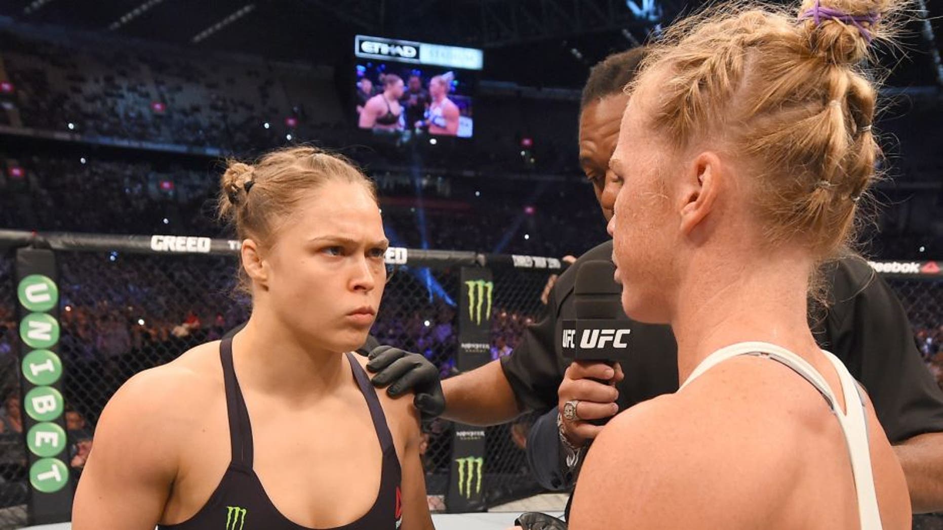 MELBOURNE, AUSTRALIA - NOVEMBER 15: (L-R) Ronda Rousey and Valerie Letourneau meet in the center of the Octagon before their UFC women's bantamweight championship bout during the UFC 193 event at Etihad Stadium on November 15, 2015 in Melbourne, Australia. (Photo by Josh Hedges/Zuffa LLC/Zuffa LLC via Getty Images)