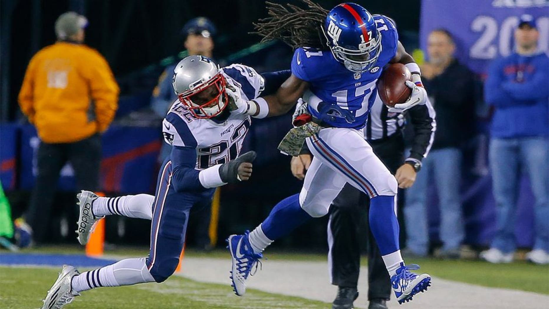 Nov 15, 2015; East Rutherford, NJ, USA; New York Giants wide receiver Dwayne Harris (17) stiff arms New England Patriots cornerback Justin Coleman (22) after a reception during the second quarter at MetLife Stadium. Mandatory Credit: Jim O'Connor-USA TODAY Sports