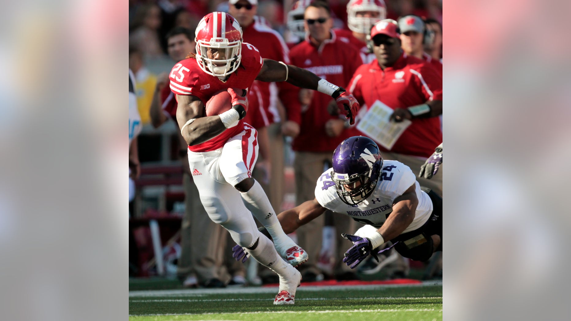 Wisconsin running back Melvin Gordon runs for a first yard against Northwestern safety Ibraheim Campbell during the first half of an NCAA college football game in Madison, Wis., Saturday, Oct. 12, 2013. Wisconsin upset Northwestern 35-6. Gordon had 176 yards. (AP Photo/Andy Manis)