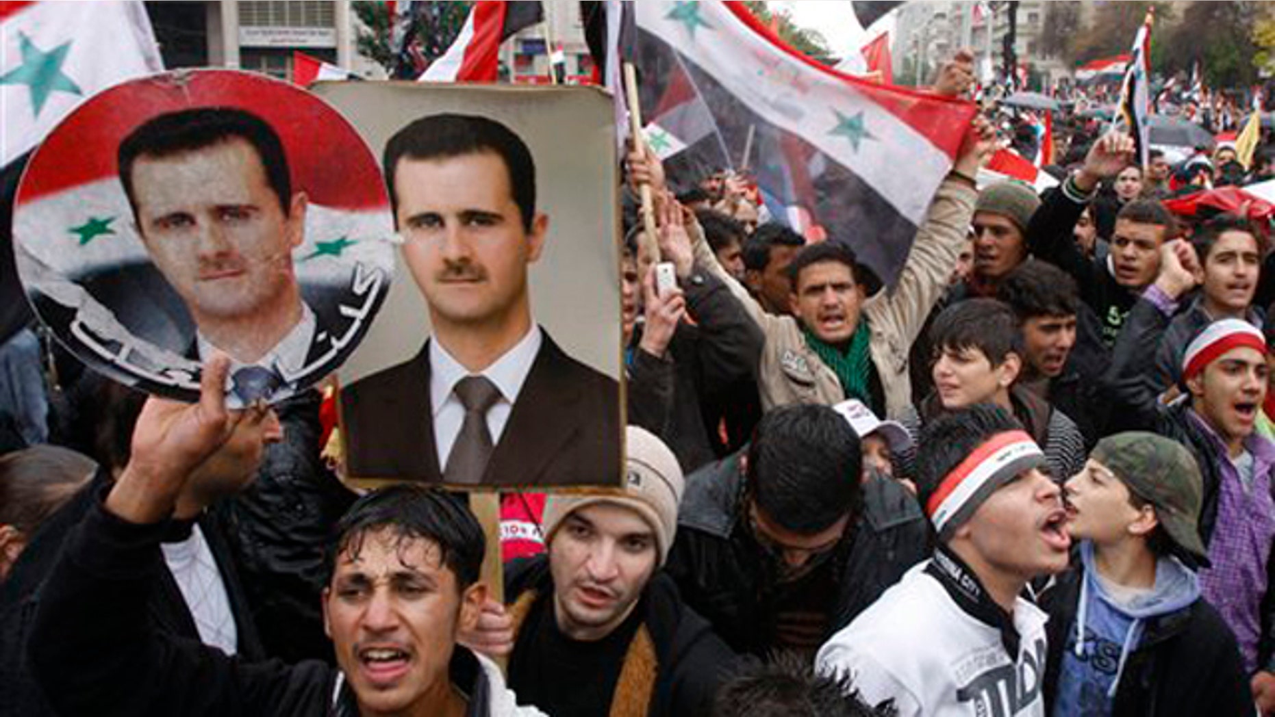 November 16, 2011: Pro-Syrian regime protesters, shout pro-Syrian President Bashar Assad slogans during a demonstration in Damascus, Syria.