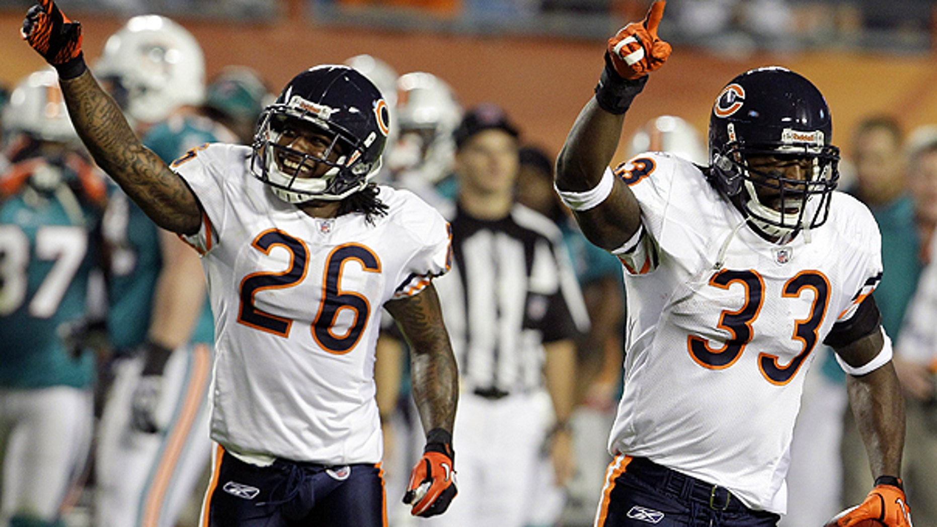 Nov. 18: Chicago Bears cornerbacks Charles Tillman (33) and Tim Jennings (26) celebrate after Tillman intercepted a pass during the first quarter of an NFL football game against the Miami Dolphins in Miami.