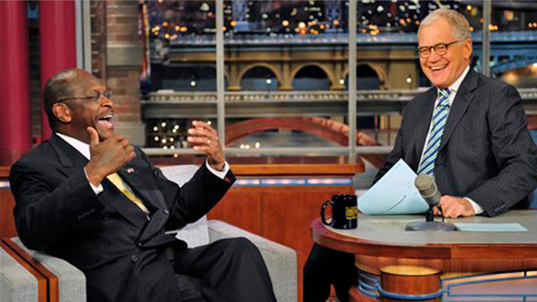 Novemeber 18, 2011:Republican presidential candidate Herman Cain joins host David Letterman on the set of the Late Show with David Letterman.