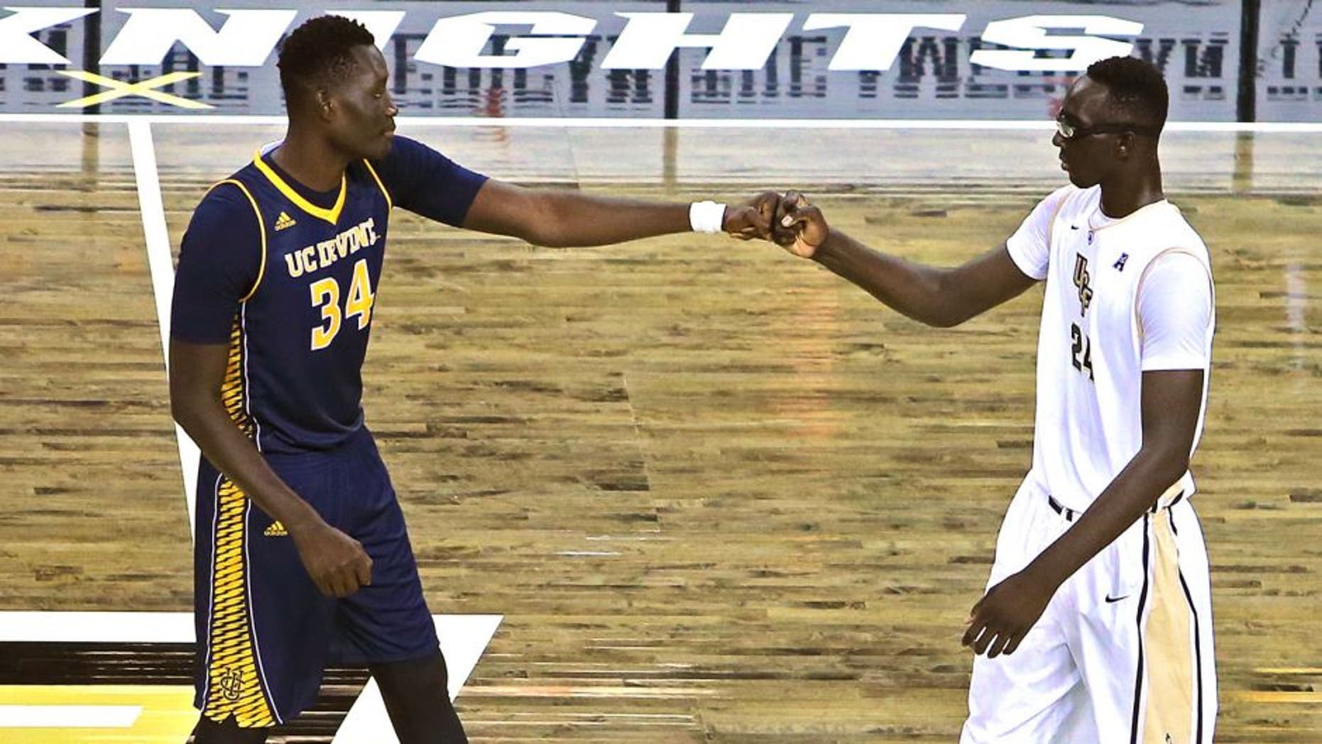 ORLANDO, FL - NOVEMBER 18: Mamadou Ndiaye #34 of the UC Irvine Anteaters (L) and Tacko Fall #24 of the UCF Knights bump fists with each other at half court prior to tipoff of an NCAA basketball game between the California-Irvine Anteaters and the UCF Knights at the CFE Arena on November 18, 2015 in Orlando, Florida. California-Irvine won the game 61-60 in overtime. (Photo by Alex Menendez/Getty Images)