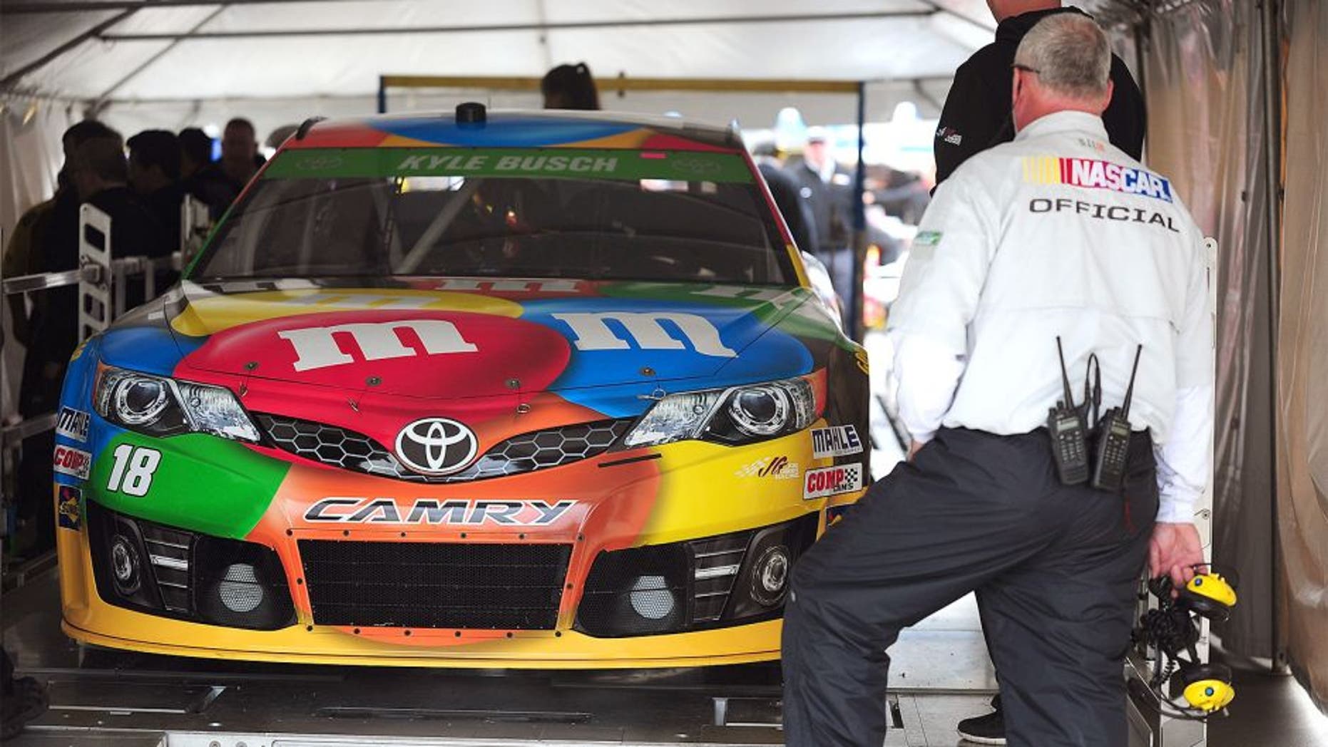 MARTINSVILLE, VA - MARCH 28: The #18 M&M's Toyota, driven by Kyle Busch, goes through technical inspection during qualifying for the NASCAR Sprint Cup Series STP 500 at Martinsville Speedway on March 28, 2014 in Martinsville, Virginia. (Photo by Jeff Curry/Getty Images)