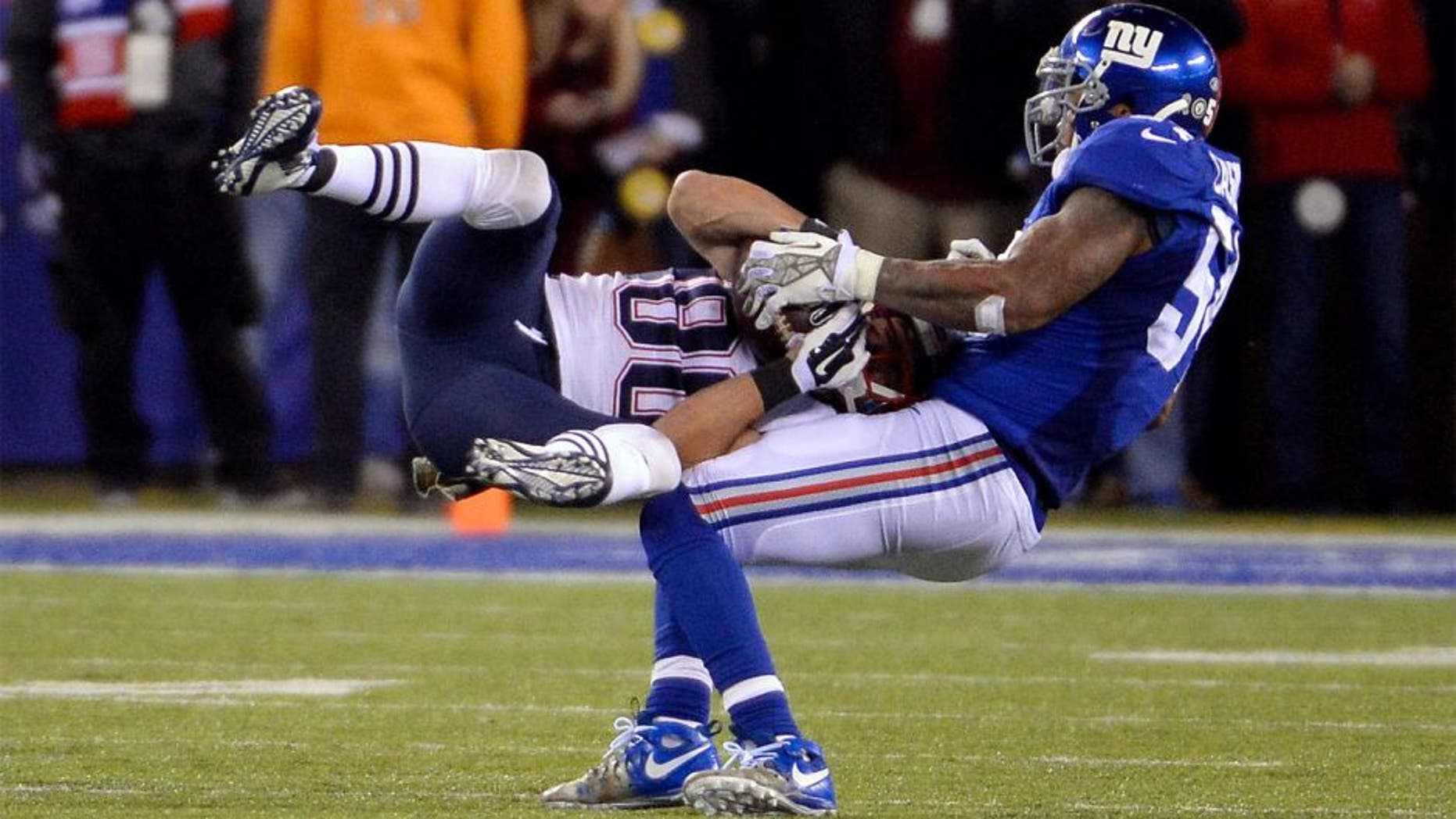 Nov 15, 2015; East Rutherford, NJ, USA; New England Patriots wide receiver Danny Amendola (80) catches a pass against New York Giants outside linebacker Jonathan Casillas (54) during the game at MetLife Stadium. Mandatory Credit: Robert Deutsch-USA TODAY Sports