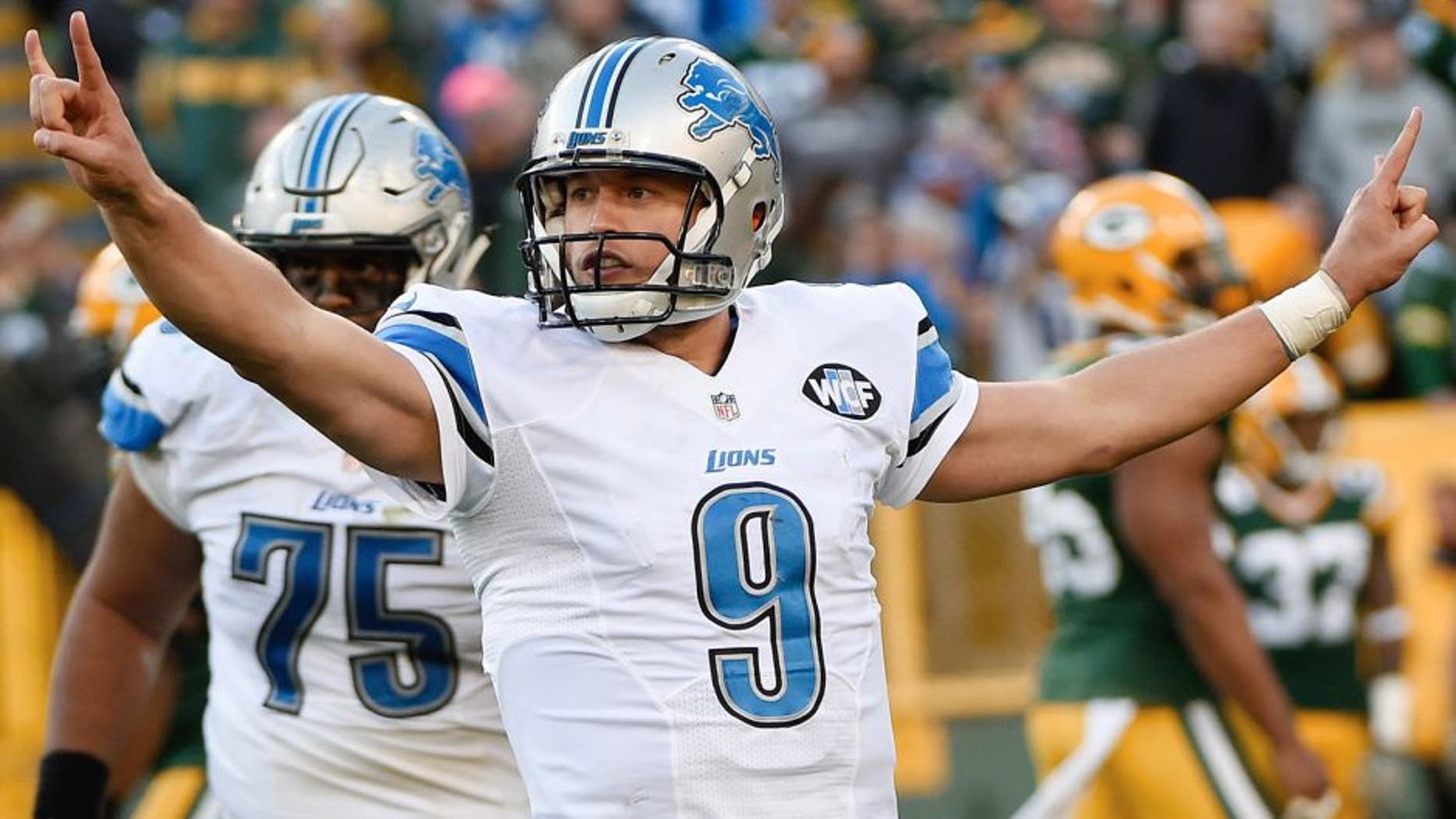 Nov 15, 2015; Green Bay, WI, USA; Detroit Lions quarterback Matthew Stafford (9) reacts after throwing a touchdown pass in the fourth quarter during the game against the Green Bay Packers at Lambeau Field. The Lions beat the Packers 18-16. Mandatory Credit: Benny Sieu-USA TODAY Sports