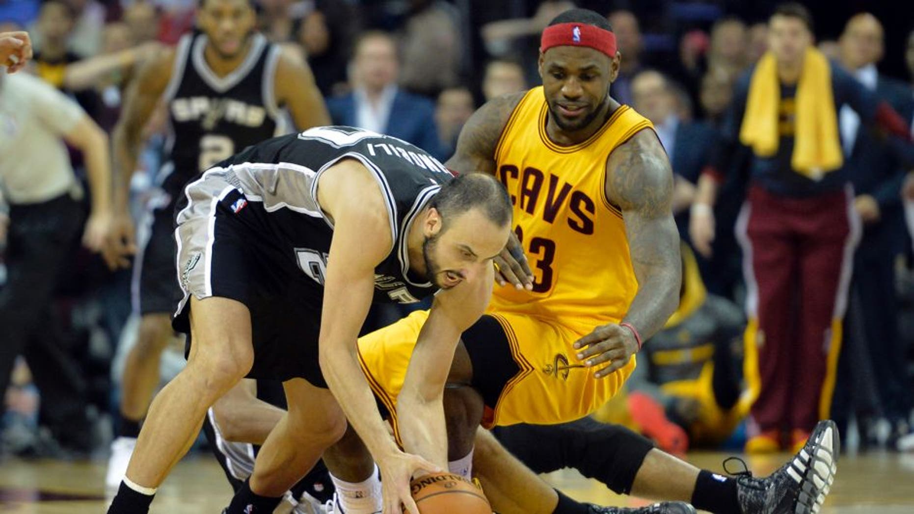 Nov 19, 2014; Cleveland, OH, USA; Cleveland Cavaliers forward LeBron James (23) watches after losing the ball to San Antonio Spurs guard Manu Ginobili (20) in the final seconds at Quicken Loans Arena. Mandatory Credit: David Richard-USA TODAY Sports