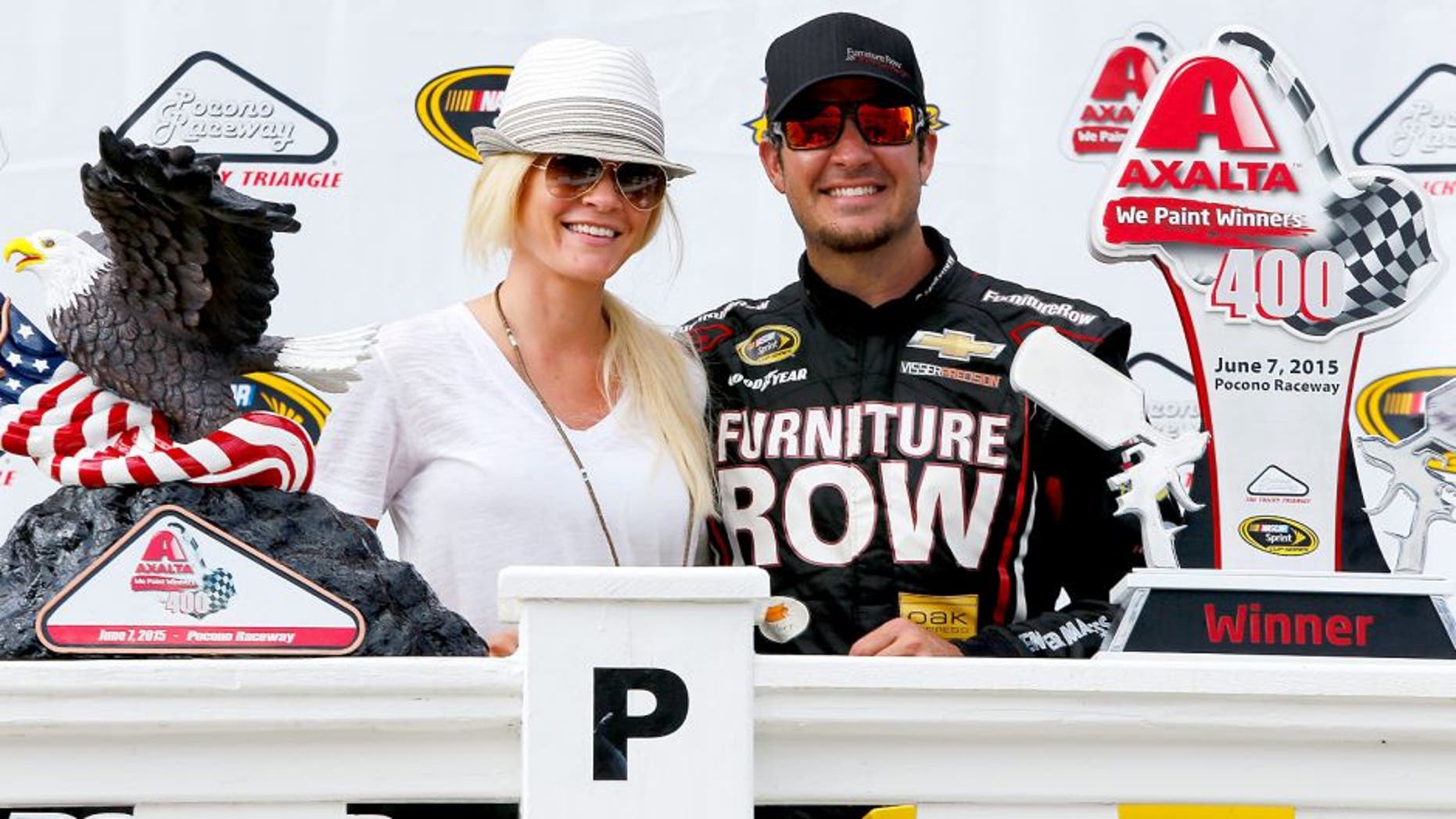 DOVER, DE - MAY 31: Martin Truex Jr., driver of the #78 Furniture Row/Visser Precision Chevrolet, right, and girlfriend Sherry Pollex take part in pre-race ceremonies for the NASCAR Sprint Cup Series FedEx 400 Benefiting Autism Speaks at Dover International Speedway on May 31, 2015 in Dover, Delaware. (Photo by Todd Warshaw/Getty Images)