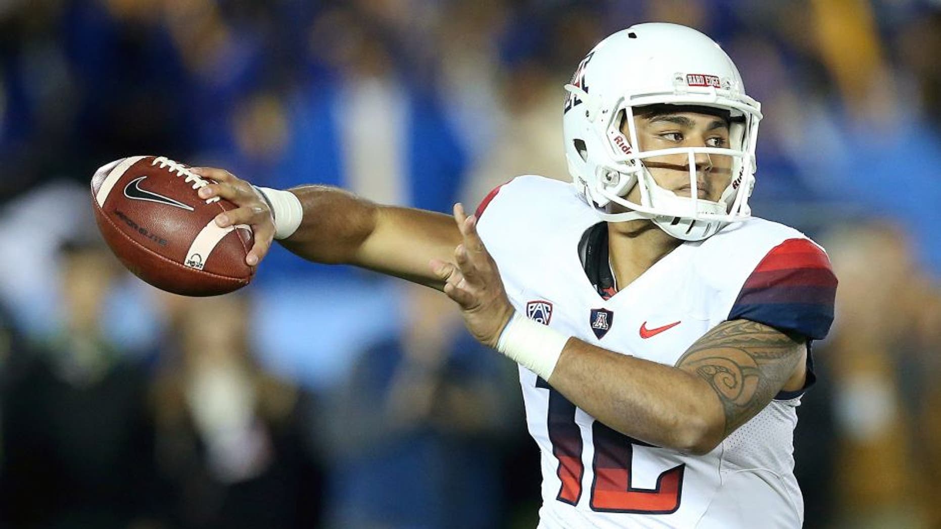 PASADENA, CA - NOVEMBER 01: Quarterback Anu Solomon #12 of the Arizona Wildcats rolls out to throw a pass against the UCLA Bruins at the Rose Bowl on November 1, 2014 in Pasadena, California. (Photo by Stephen Dunn/Getty Images)