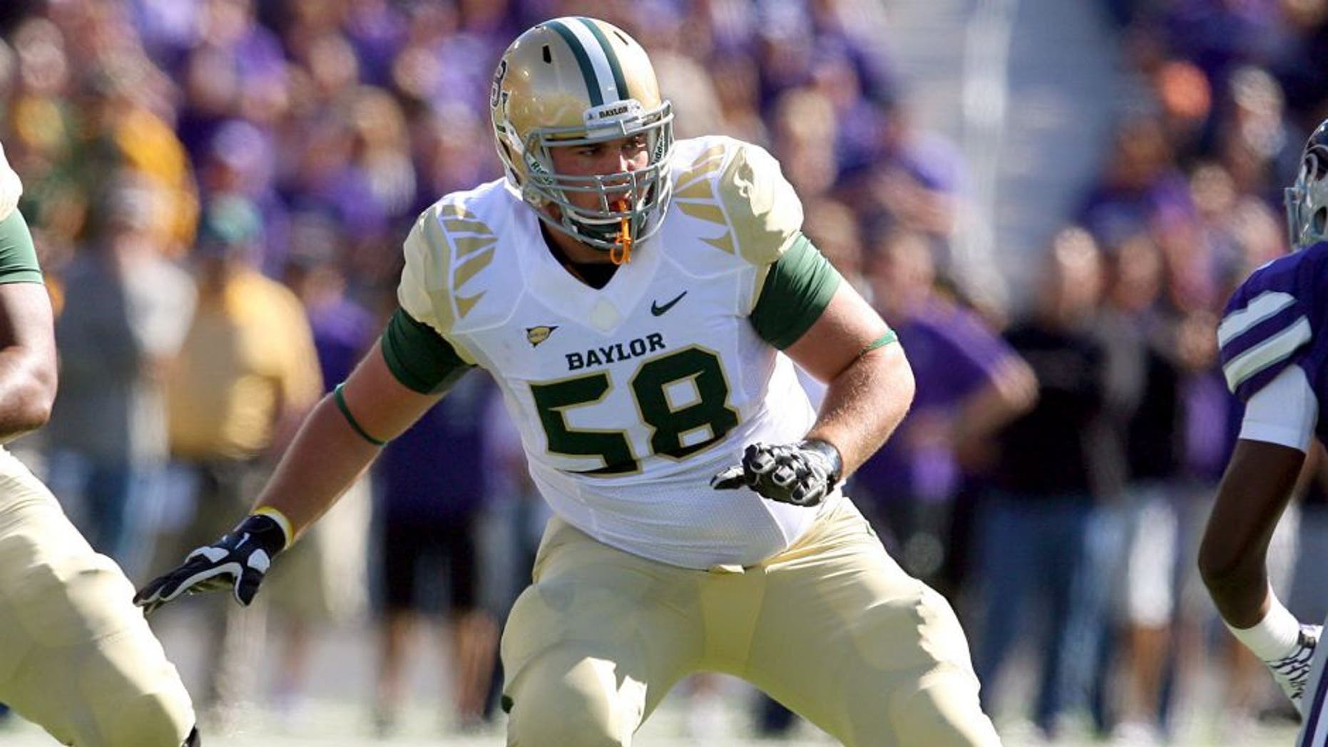 Oct 12, 2013; Manhattan, KS, USA; Baylor Bears offensive linesman Spencer Drango (58) looks to block Kansas State Wildcats linebacker Charmeachealle Moore (52) during a game at Bill Snyder Family Stadium. Mandatory Credit: Scott Sewell-USA TODAY Sports