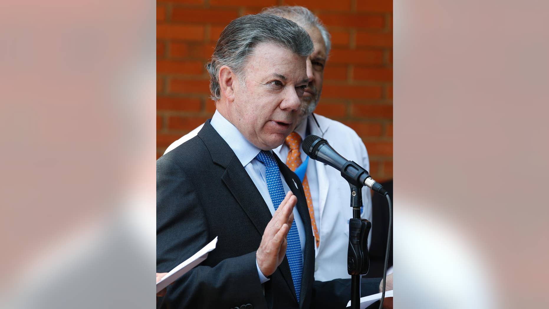 Colombia's President Juan Manuel Santos gives a press conference at the Santa Fe clinic in Bogota, Colombia, Monday, Nov. 21, 2016. Santos said he will undergo radiation to treat high levels of a prostate-specific antigen that his doctors say don’t represent a return of cancer. (AP Photo/Fernando Vergara)