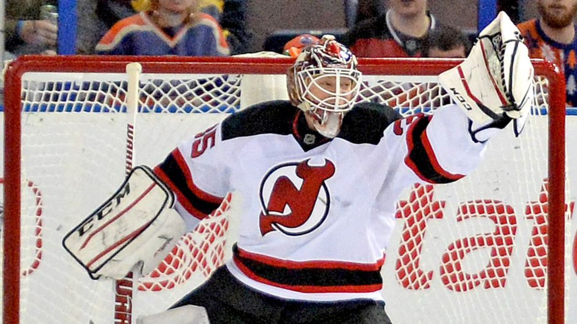 Nov 21, 2014; Edmonton, Alberta, CAN; New Jersey Devils goalie Cory Schneider (35) makes a glove save against the Edmonton Oilers in the second period at Rexall Place. Mandatory Credit: Chris LaFrance-USA TODAY Sports