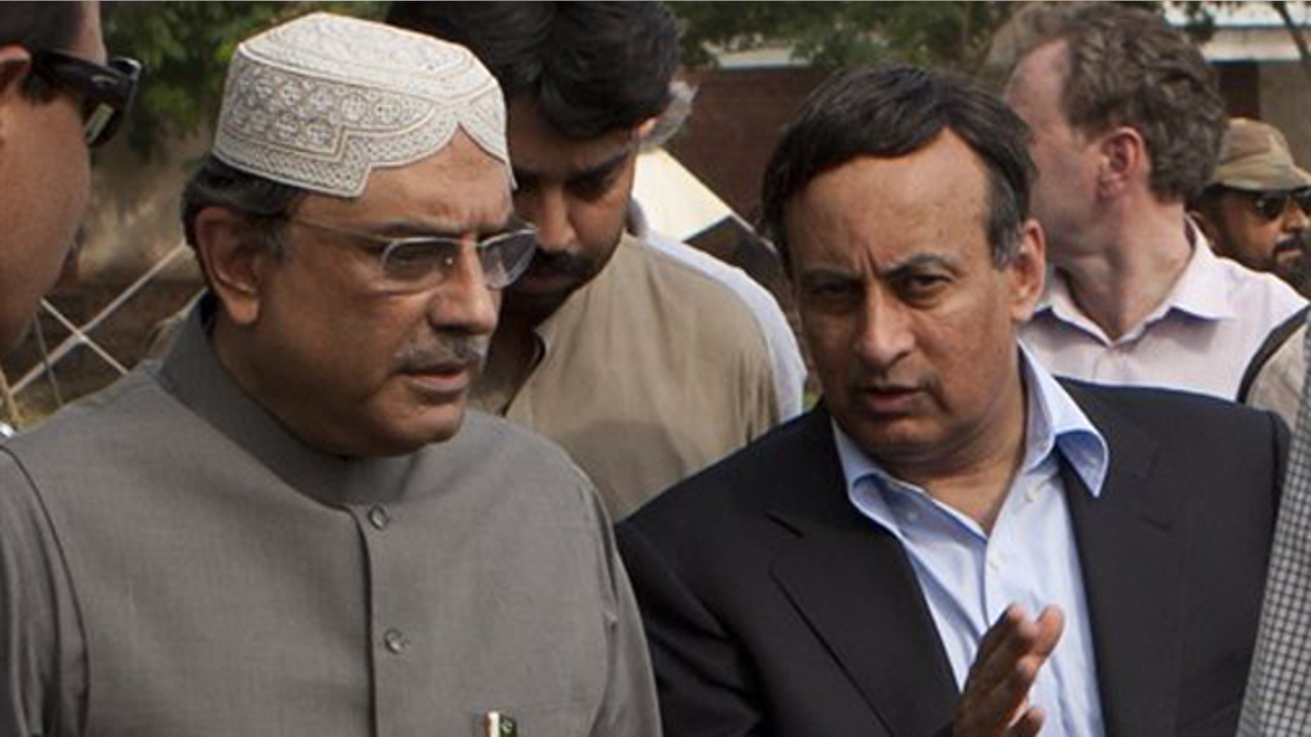 August 19, 2010: Pakistan's Ambassador in Washington Hussain Haqqani, right, talks with Pakistan's President Asif Ali Zardari in Multan, Pakistan.