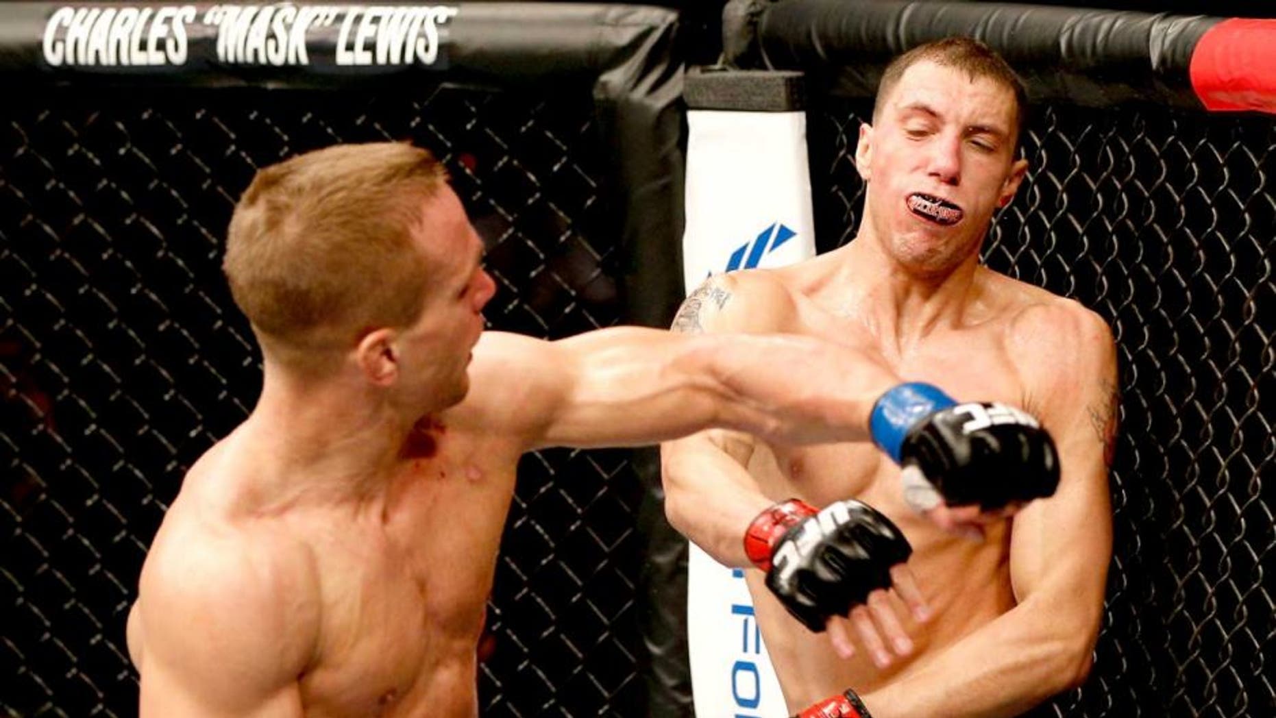 AUSTIN, TX - NOVEMBER 22: (L-R) Nick Hein of Germany punches James Vick in their lightweight bout during the UFC Fight Night event at The Frank Erwin Center on November 22, 2014 in Austin, Texas. (Photo by Josh Hedges/Zuffa LLC/Zuffa LLC via Getty Images)