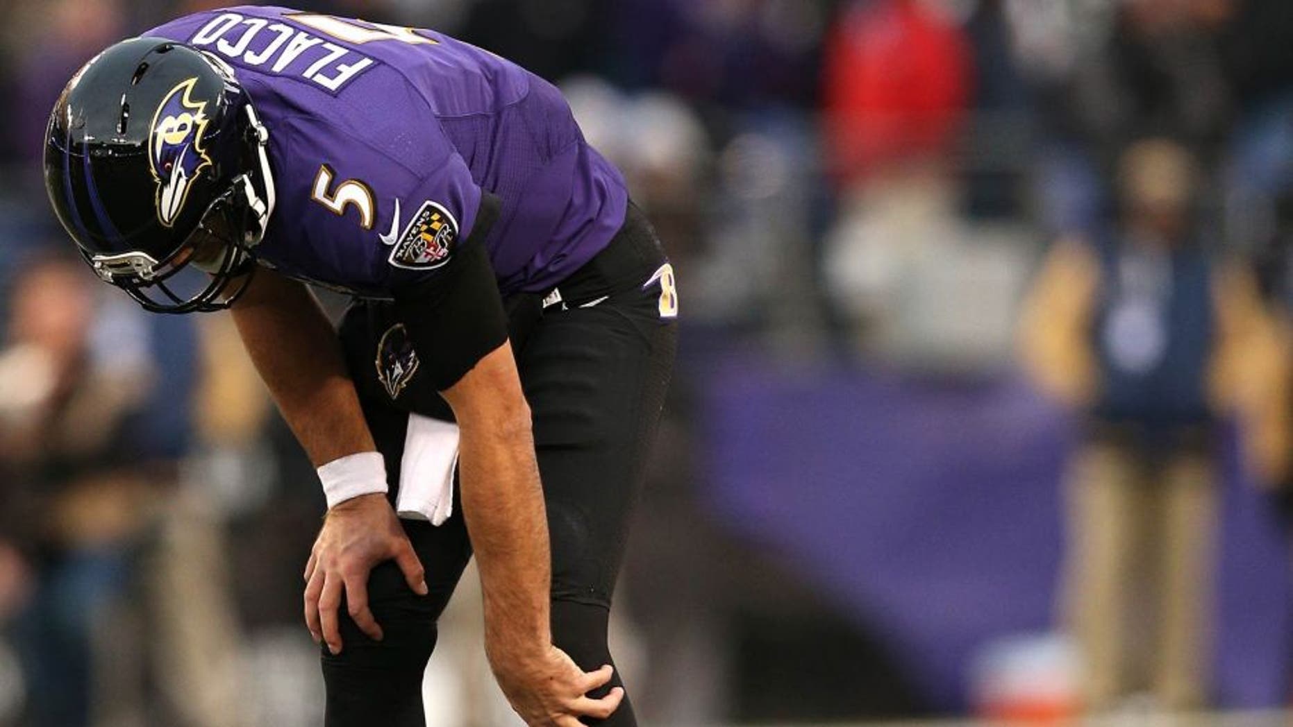 BALTIMORE, MD - NOVEMBER 22: Quarterback Joe Flacco #5 of the Baltimore Ravens winces in pain on the final drive of the fourth quarter against the St. Louis Rams at M&T Bank Stadium on November 22, 2015 in Baltimore, Maryland. The Baltimore Ravens won, 16-13. (Photo by Patrick Smith/Getty Images)