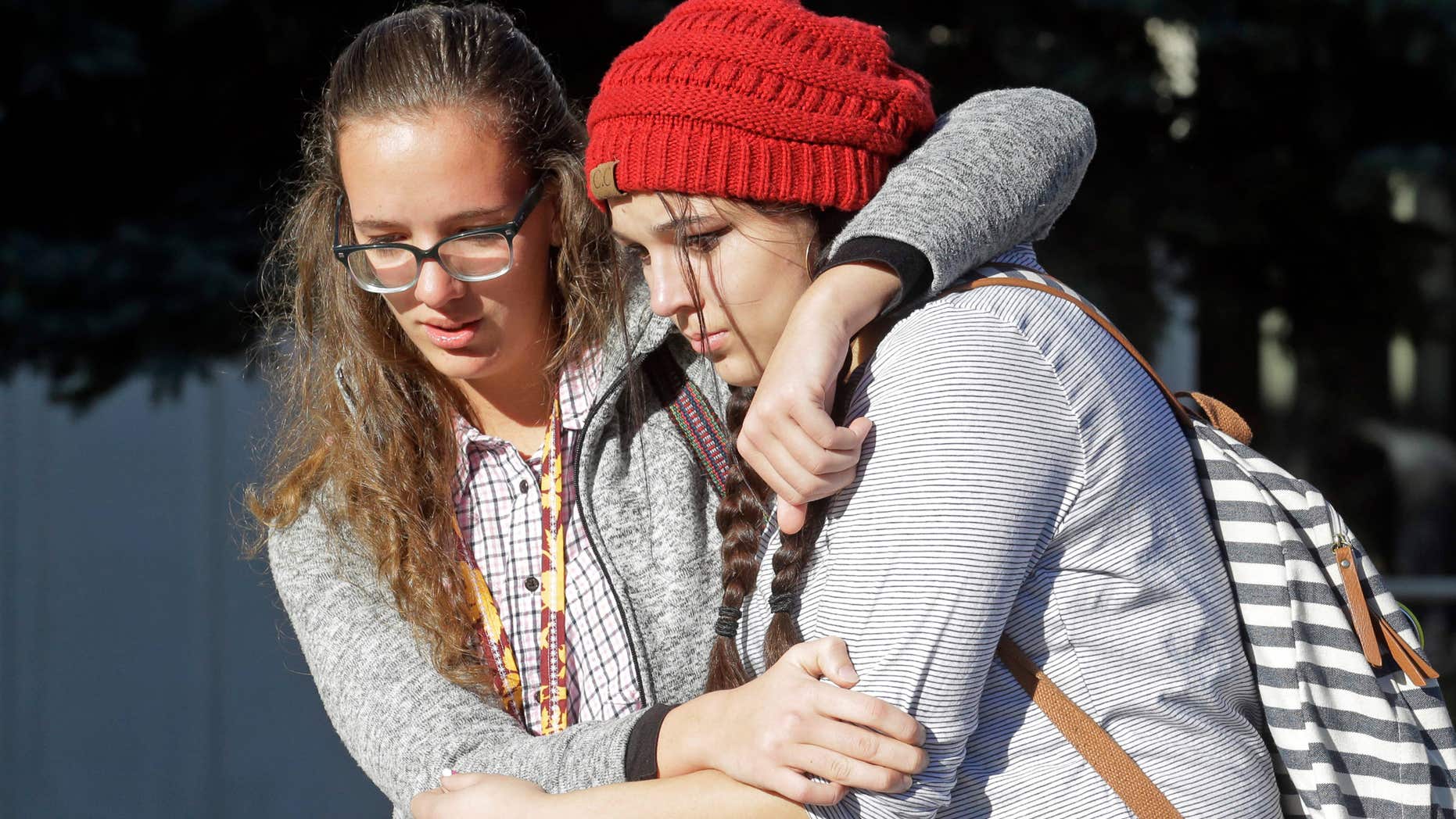 Students Albany Cox, right, and Holly Hilton leave Mountain View High School where several students were stabbed Tuesday, Nov. 15, 2016, in Orem, Utah.