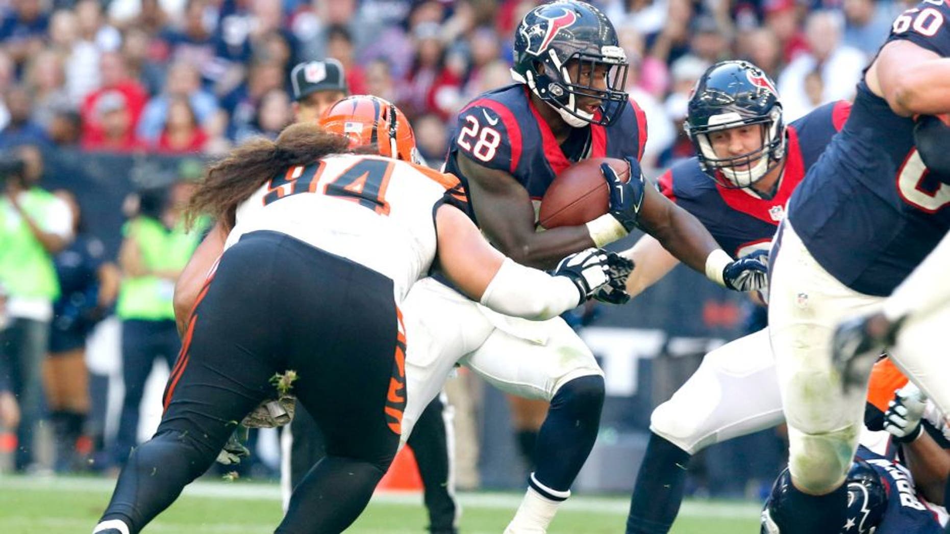 Nov 23, 2014; Houston, TX, USA; Houston Texans running back Alfred Blue (28) runs with the ball against Cincinnati Bengals nose tackle Domata Peko (94) at NRG Stadium. Mandatory Credit: Matthew Emmons-USA TODAY Sports