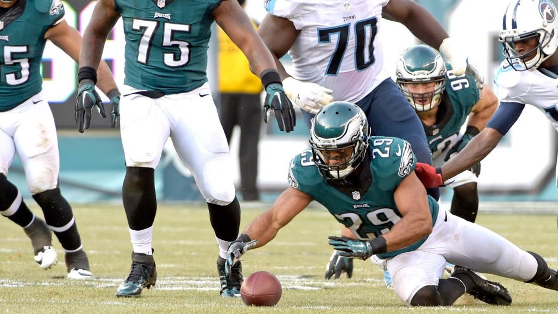 Nov 23, 2014; Philadelphia, PA, USA; Philadelphia Eagles strong safety Nate Allen (29) recovers a fumble during third quarter against the Tennessee Titans at Lincoln Financial Field. The Eagles defeated the Titans, 43-24. Mandatory Credit: Eric Hartline-USA TODAY Sports