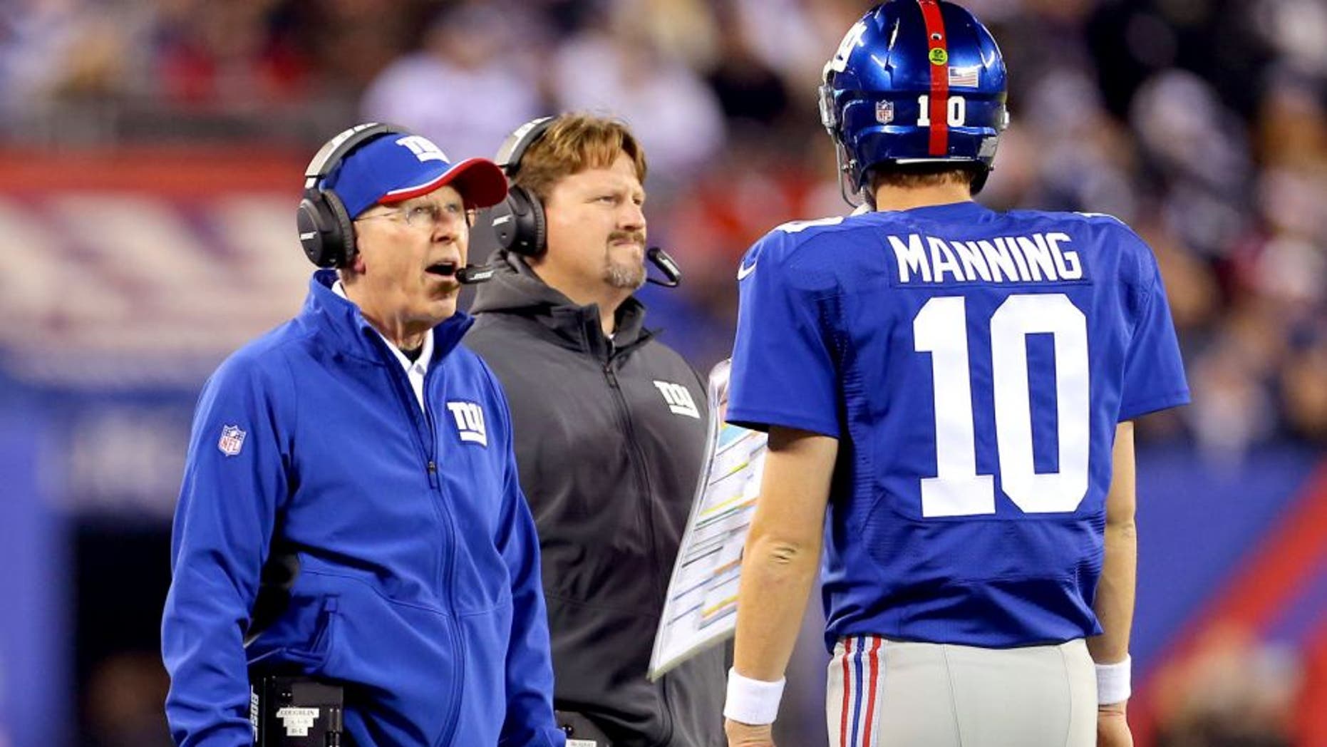 Nov 23, 2014; East Rutherford, NJ, USA; New York Giants head coach Tom Coughlin and offensive coordinator Ben McAdoo talk with quarterback Eli Manning (10) during a break in play against the Dallas Cowboys during the second quarter at MetLife Stadium. Mandatory Credit: Adam Hunger-USA TODAY Sports