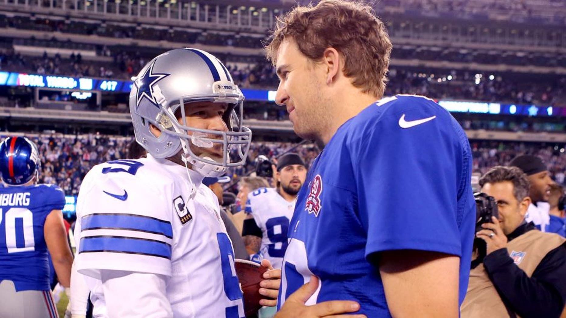 Nov 23, 2014; East Rutherford, NJ, USA; Dallas Cowboys quarterback Tony Romo (9) and New York Giants quarterback Eli Manning (10) after their game at MetLife Stadium. The Cowboys defeated the Giants 31-28. Mandatory Credit: Adam Hunger-USA TODAY Sports