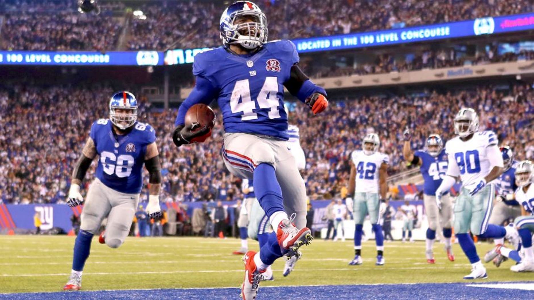 Nov 23, 2014; East Rutherford, NJ, USA; New York Giants running back Andre Williams (44) scores a touchdown against the Dallas Cowboys during the second quarter at MetLife Stadium. Mandatory Credit: Adam Hunger-USA TODAY Sports