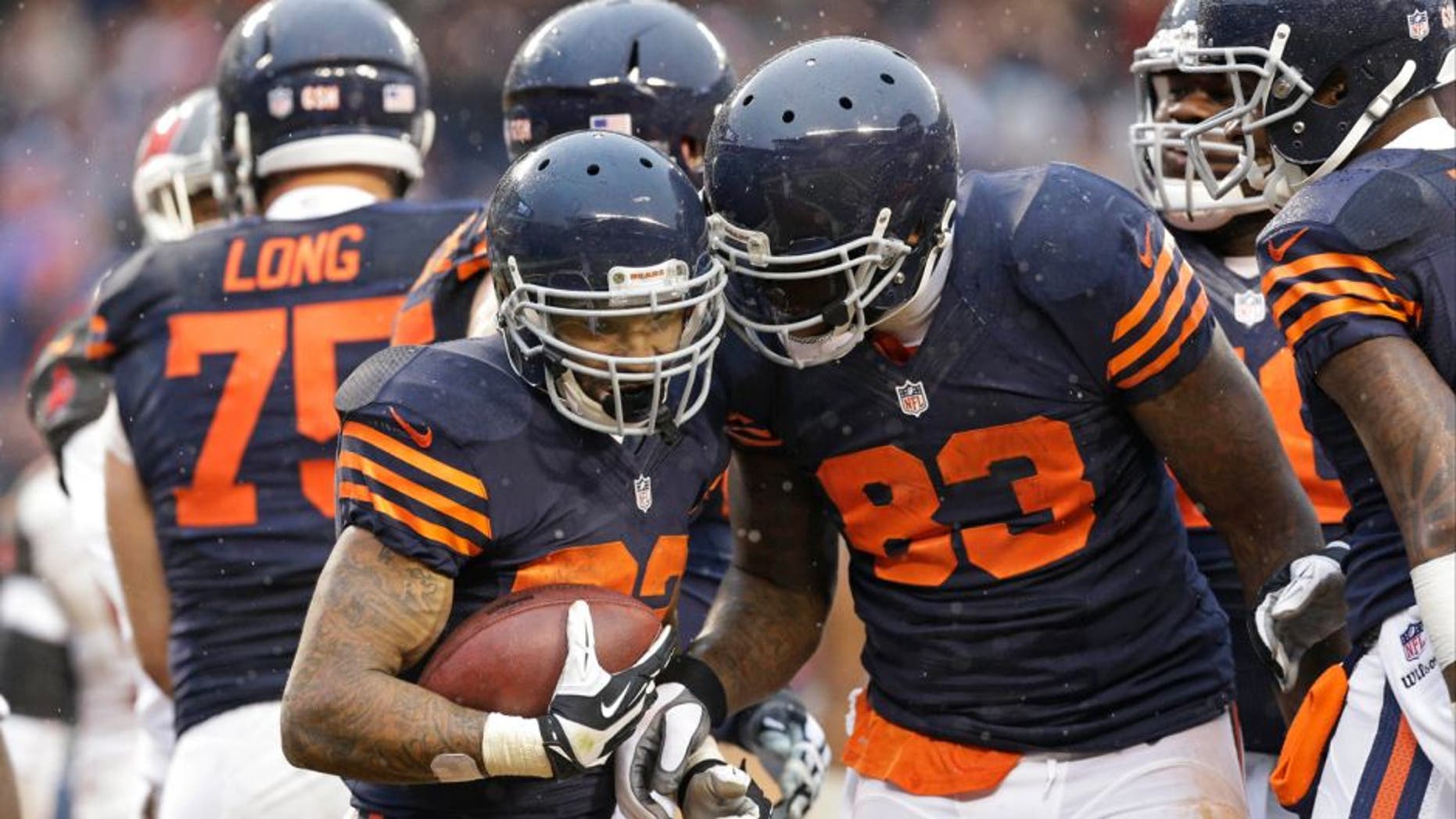 Chicago Bears running back Matt Forte (22) is congratulated by teammate Martellus Bennett (83) after his touchdown run during the second half of an NFL football game against the Tampa Bay Buccaneers Sunday, Nov. 23, 2014, in Chicago. (AP Photo/Nam Y. Huh)