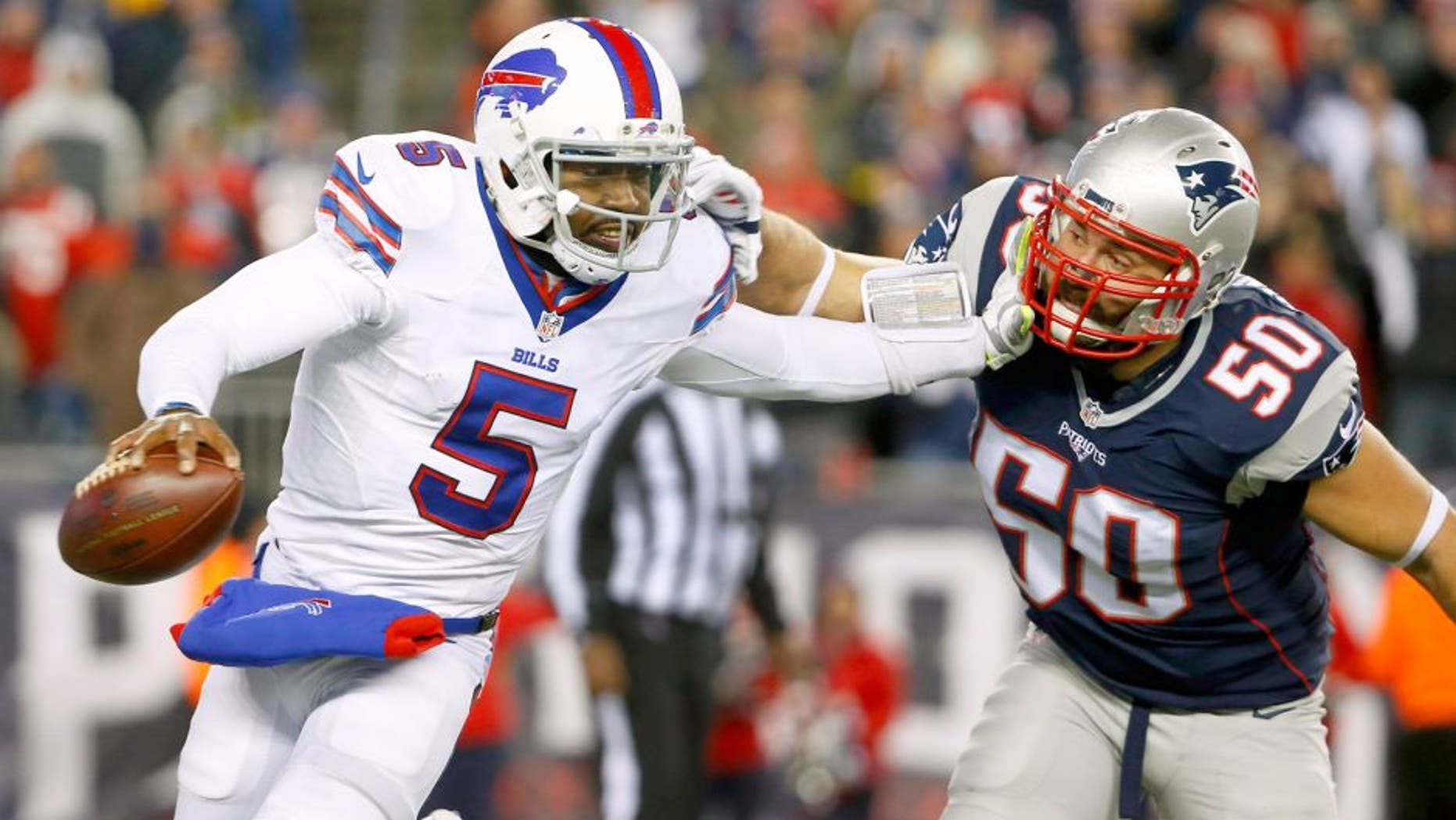Nov 23, 2015; Foxborough, MA, USA; Buffalo Bills quarterback Tyrod Taylor (5) tries to break free from New England Patriots defensive end Rob Ninkovich (50) during the second half at Gillette Stadium. Mandatory Credit: Winslow Townson-USA TODAY Sports