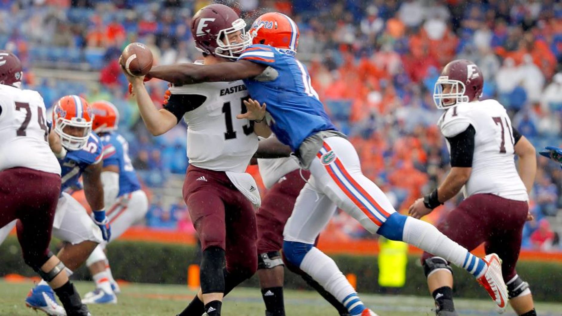 Nov 22, 2014; Gainesville, FL, USA; Florida Gators defensive lineman Alex McCalister (14) sacks Eastern Kentucky Colonels quarterback Barton Mann (15) during the second half at Ben Hill Griffin Stadium. Florida Gators defeated the Eastern Kentucky Colonels 52-3. Mandatory Credit: Kim Klement-USA TODAY Sports